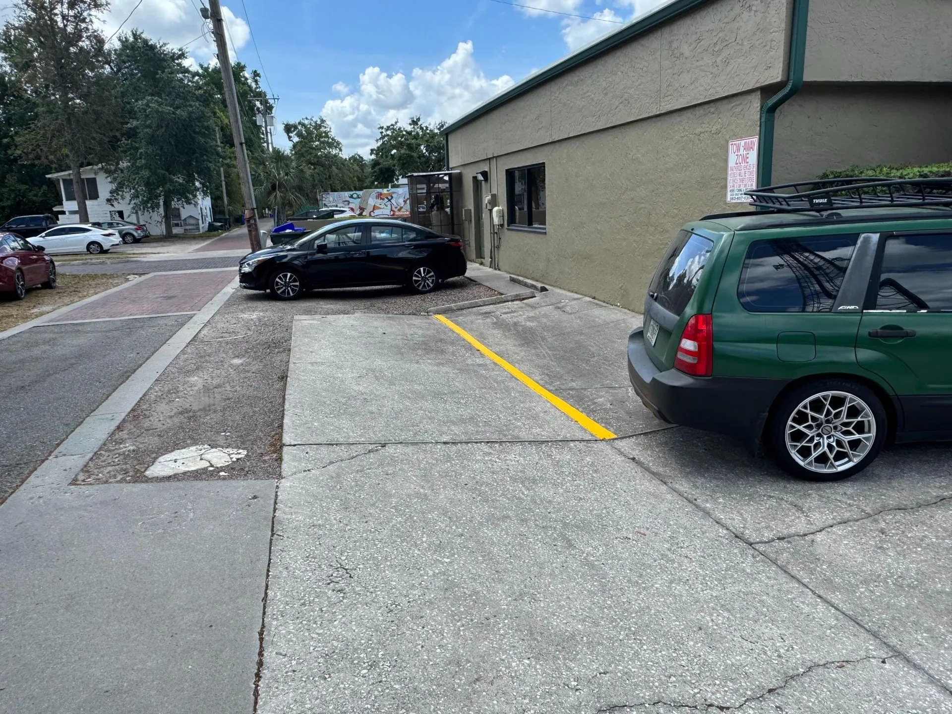 Small business property with newly painted parking space lines, improving parking organization and maximizing available vehicle spaces.