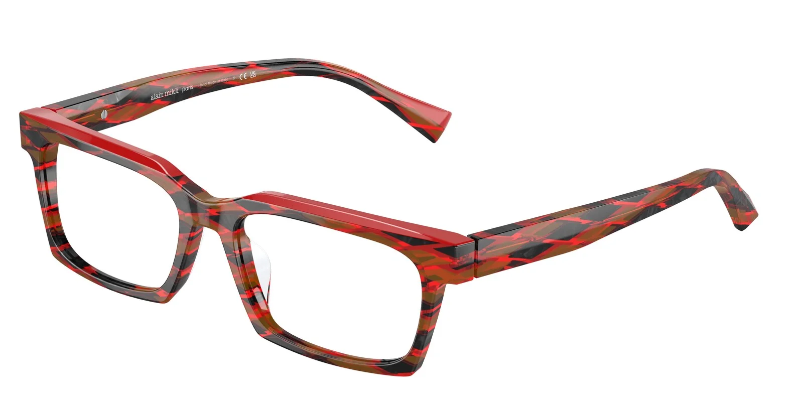 A pair of bold, angular eyeglasses with a red, black, and brown abstract pattern is presented against a white background. The glasses have thick frames and straight temples, with the brand name 'ALAIN MIKLI PARIS' subtly printed on the inside of one temple arm, along with 'Hand Made in Italy' and CE/UKCA markings.