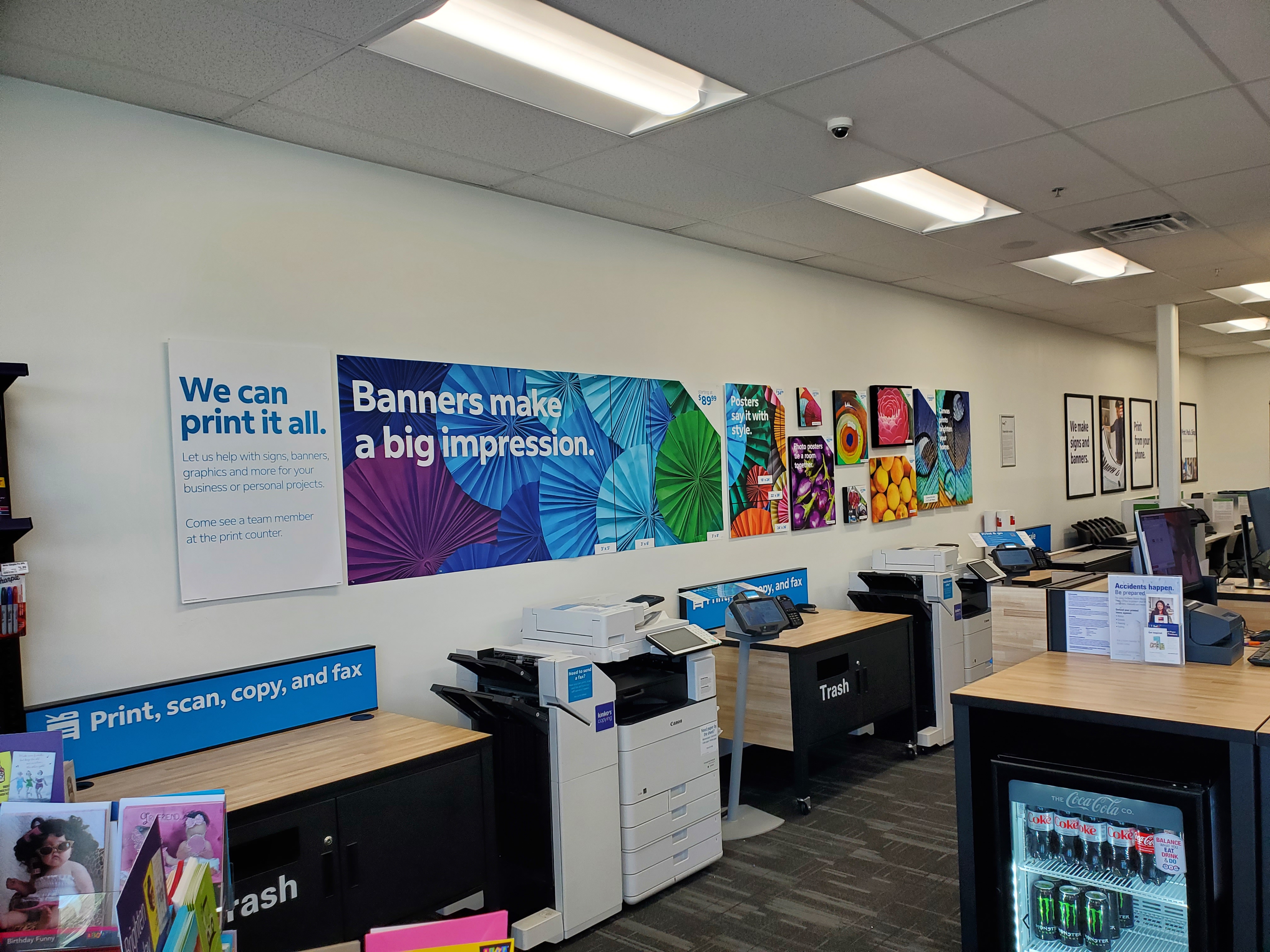 Self-service printing, copying, and scanning area at FedEx Office in College Station Texas with printers and workstations for customer use.