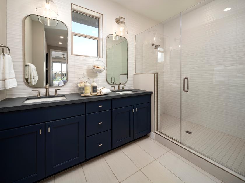 Beautiful primary bathroom with accent walls and glass shower door