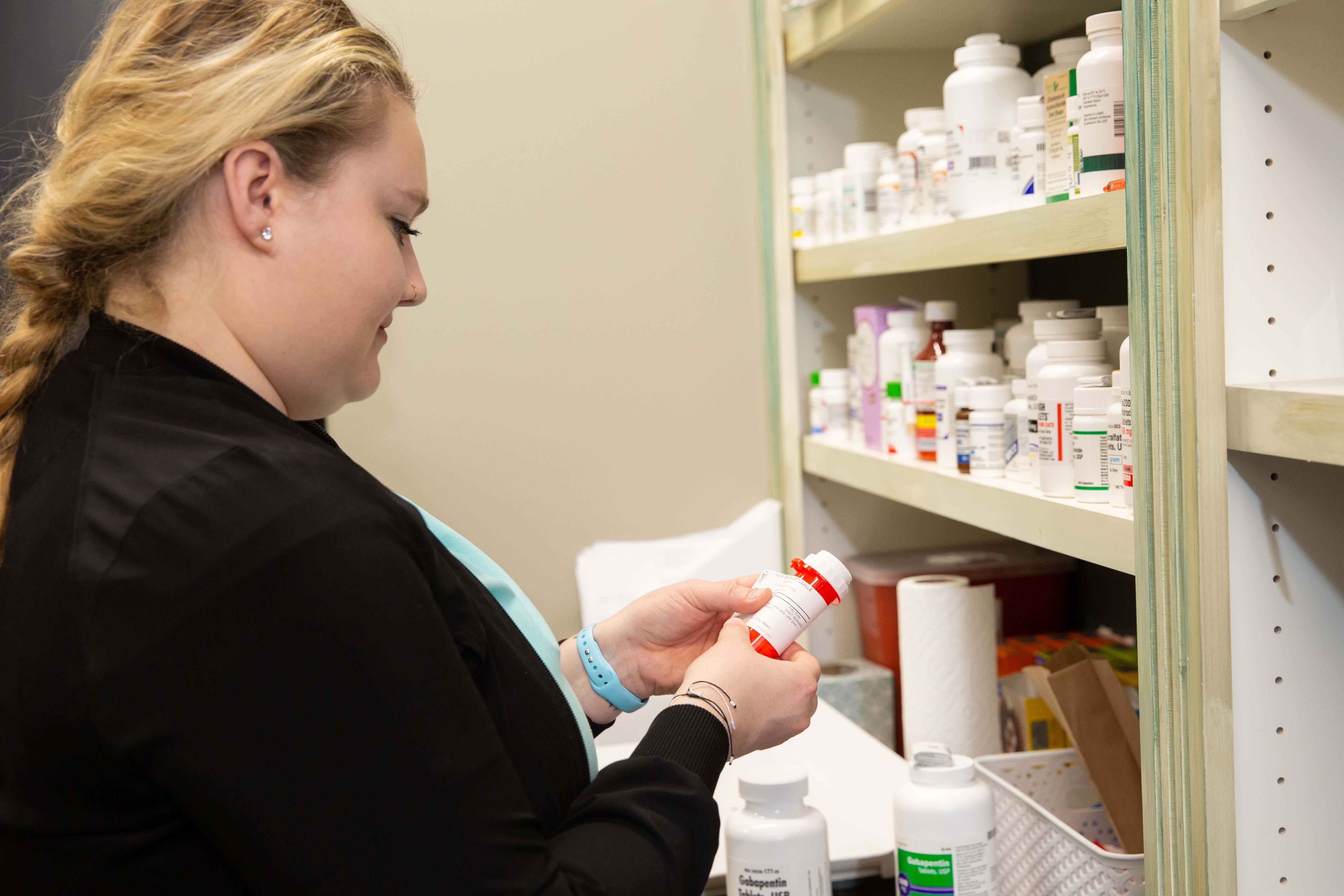One of our wonderful team members carefully fills medication for a patient.