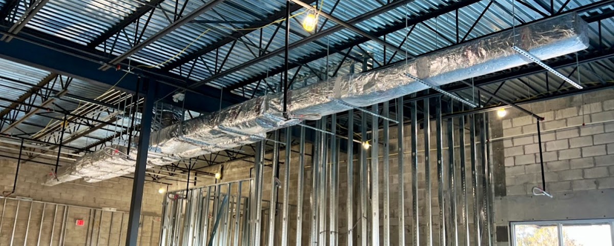 Exposed commercial HVAC ductwork and ceiling installation designed to support efficient airflow throughout the building.