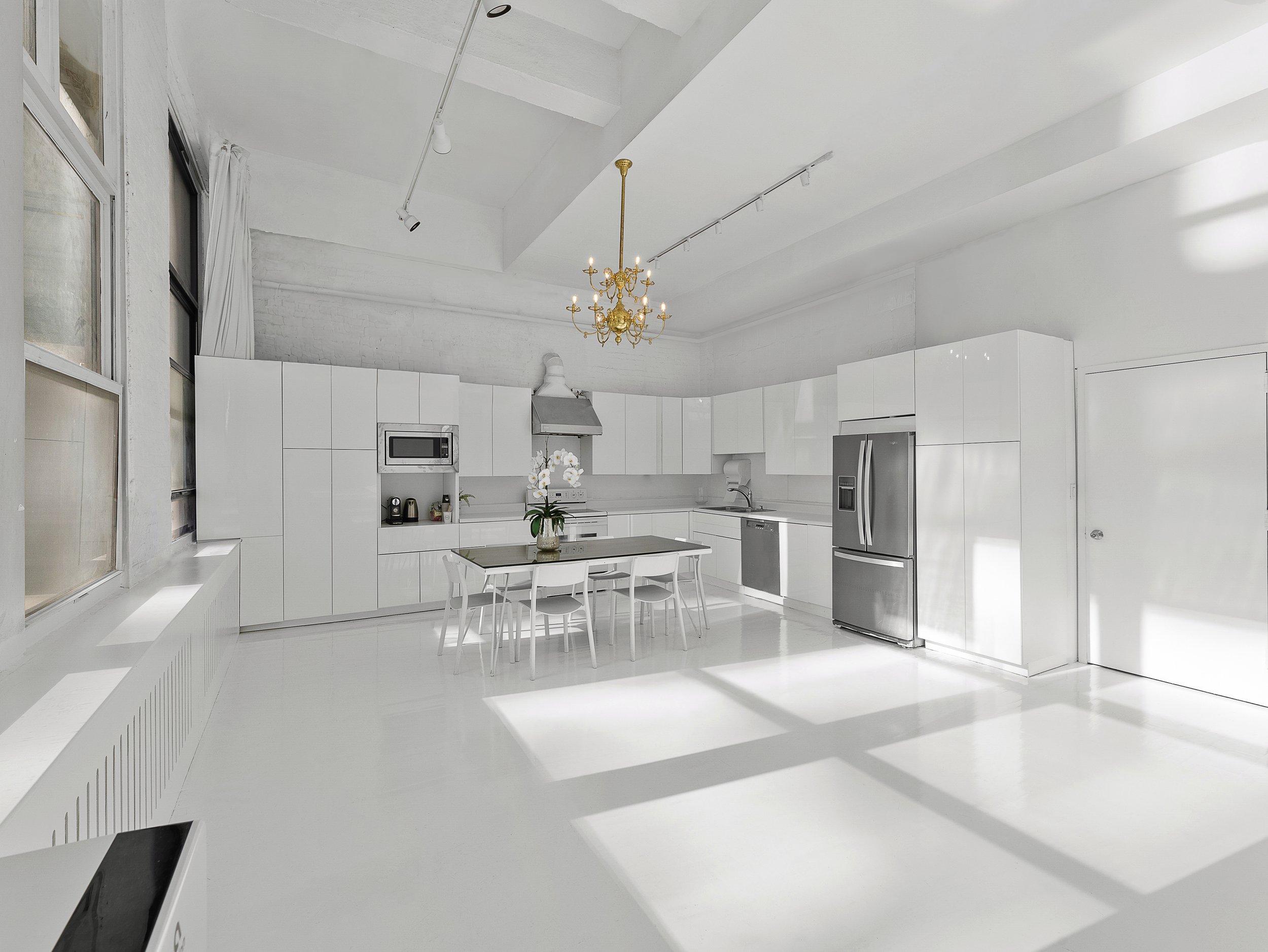 white open 2,300 SF Studio 9, Venue Hudson Yards NYC, fully functional kitchen, food and still life photography, natural daylight, white floors, 15' ceiling, food shoot and production studio rental New York.