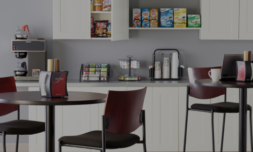 Breakroom essentials featuring coffee dispensers, disposable cups, napkins, and snacks for a well-stocked workspace