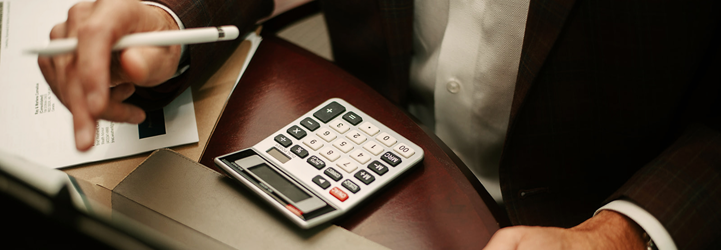 A top-down view of a professional and a calculator.