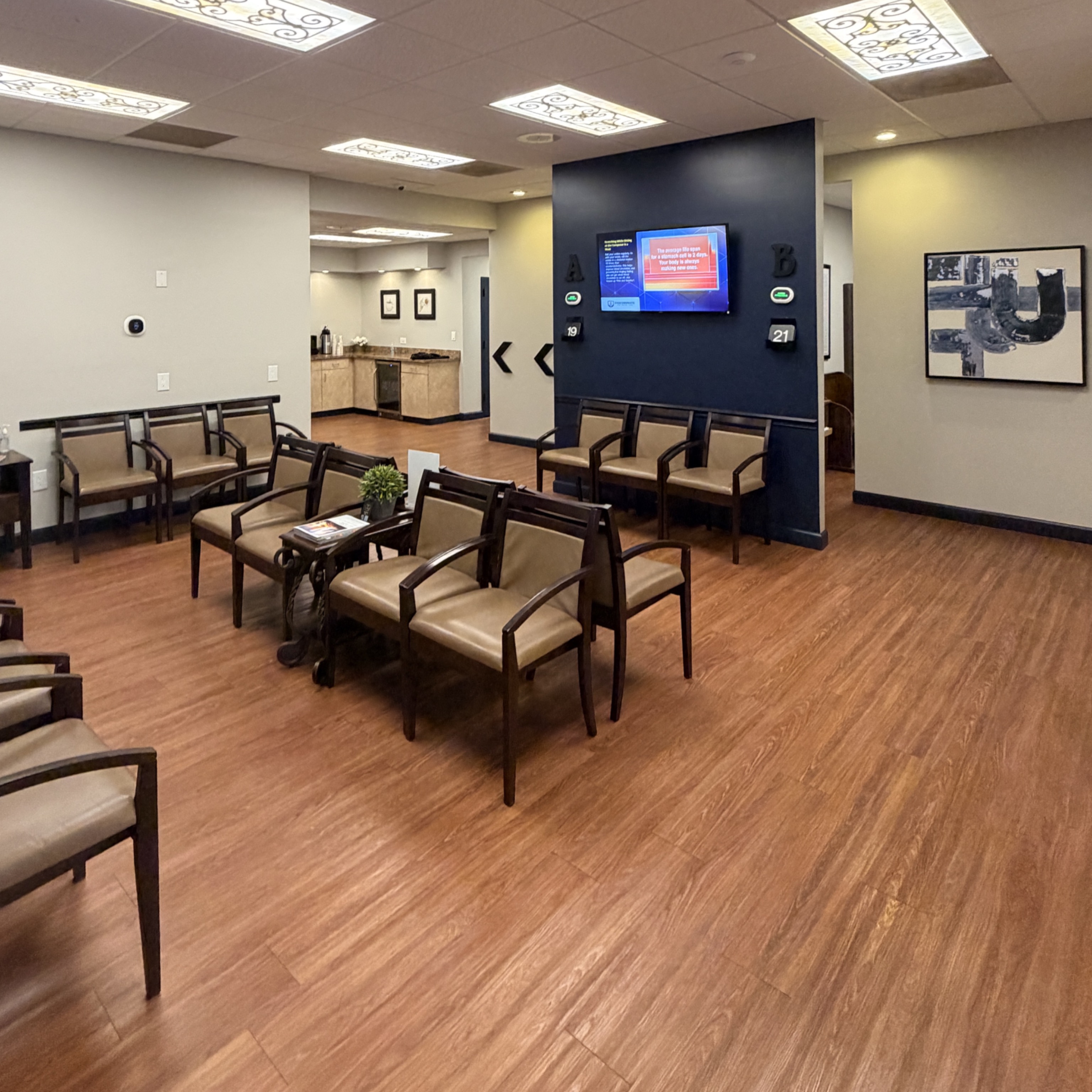 Our roomy, well-lit waiting area, with plenty of seating and health tips playing on the screens. 