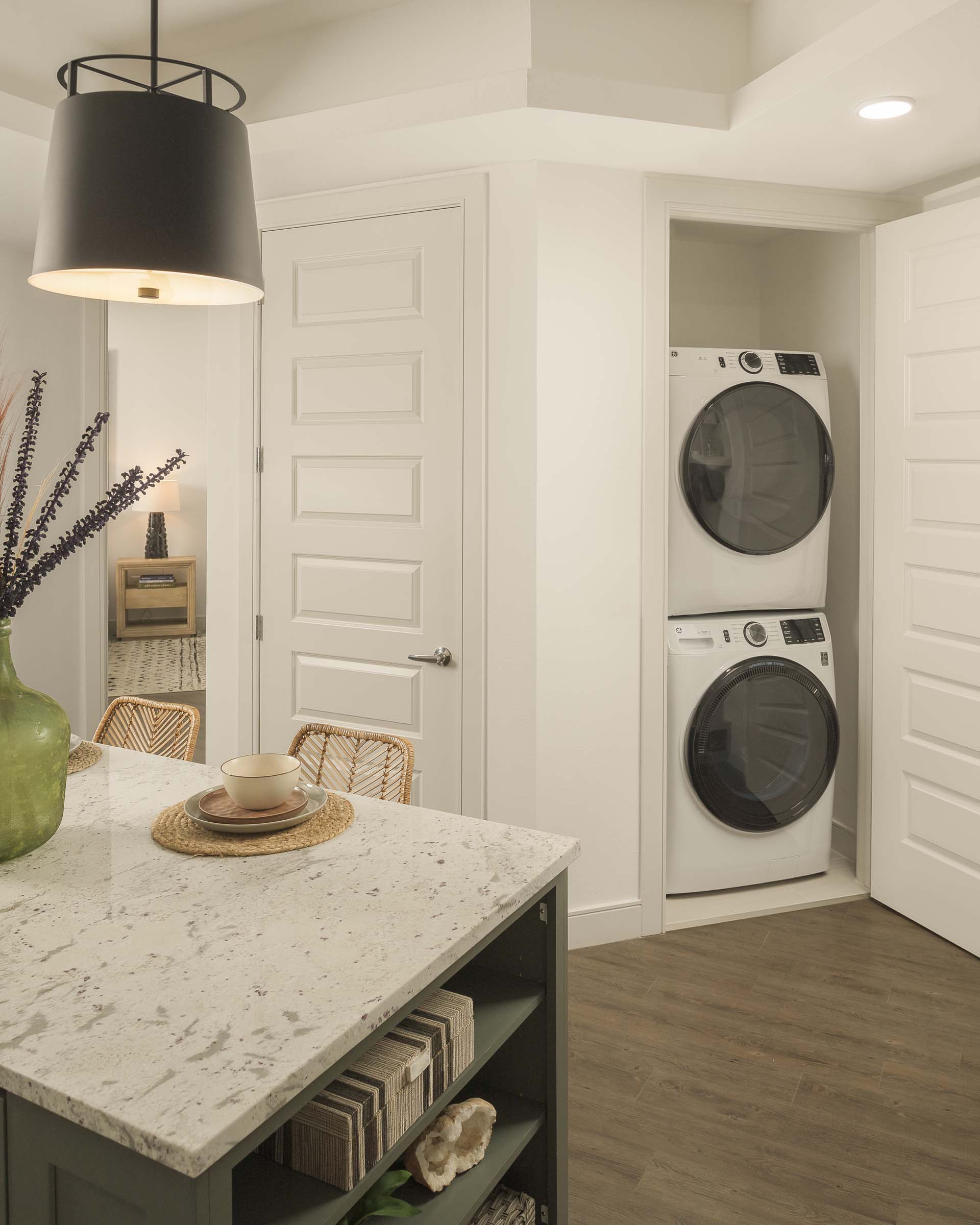 Stackable washer and dryer near the kitchen island at Camden Gilbert apartment homes in Gilbert, AZ