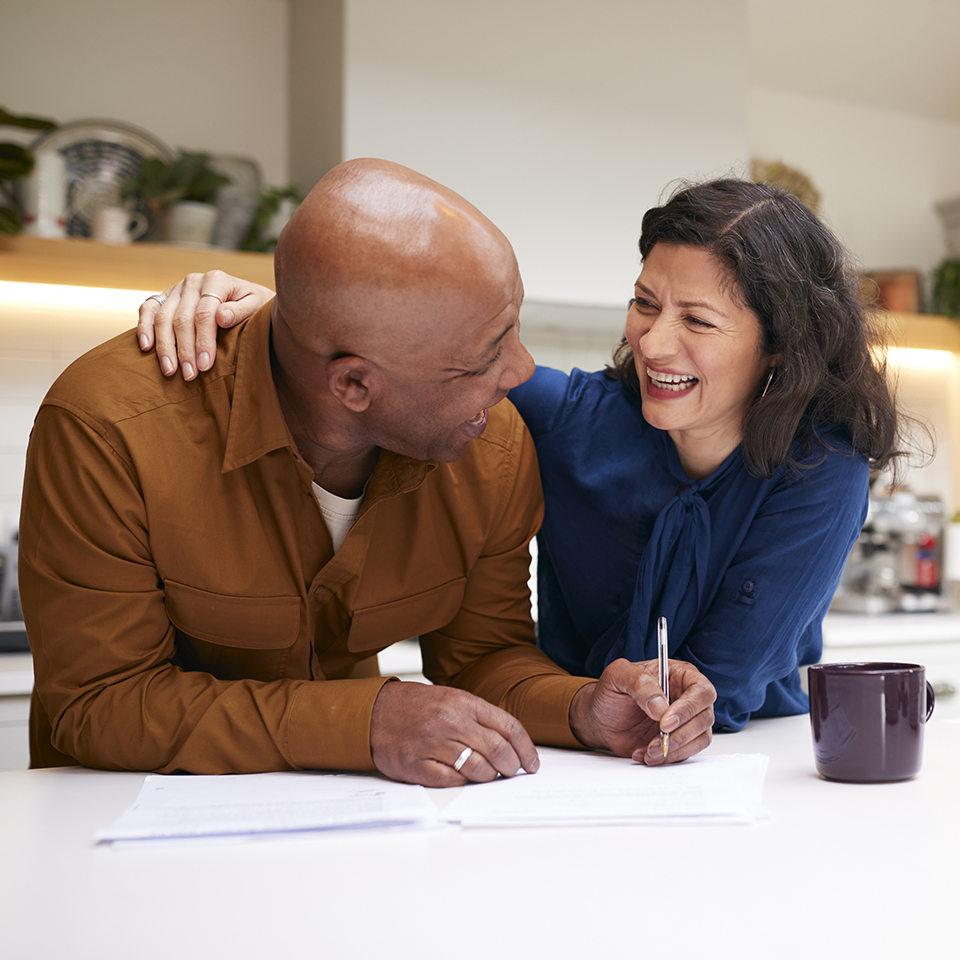 Two people smiling in a kitchen