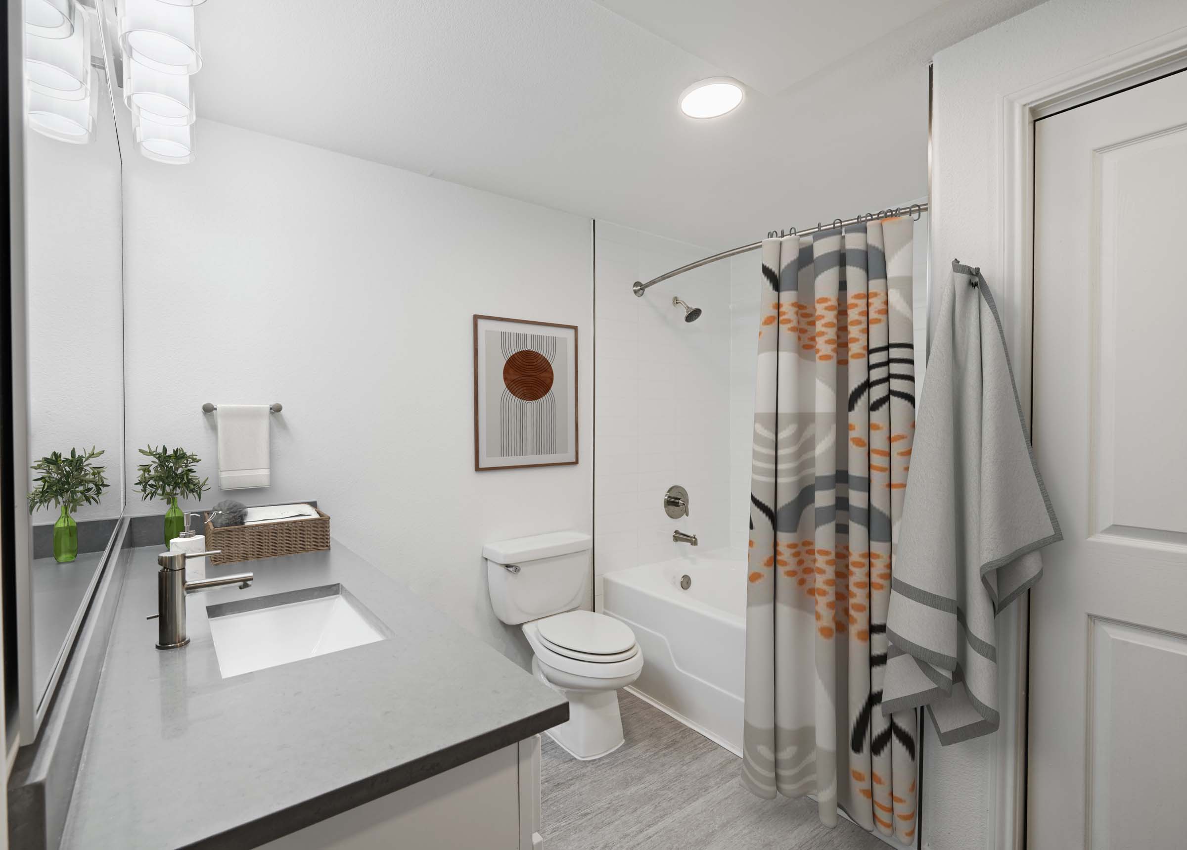 Bathroom with quartz countertop and garden bathtub at Camden Heights in Houston, TX