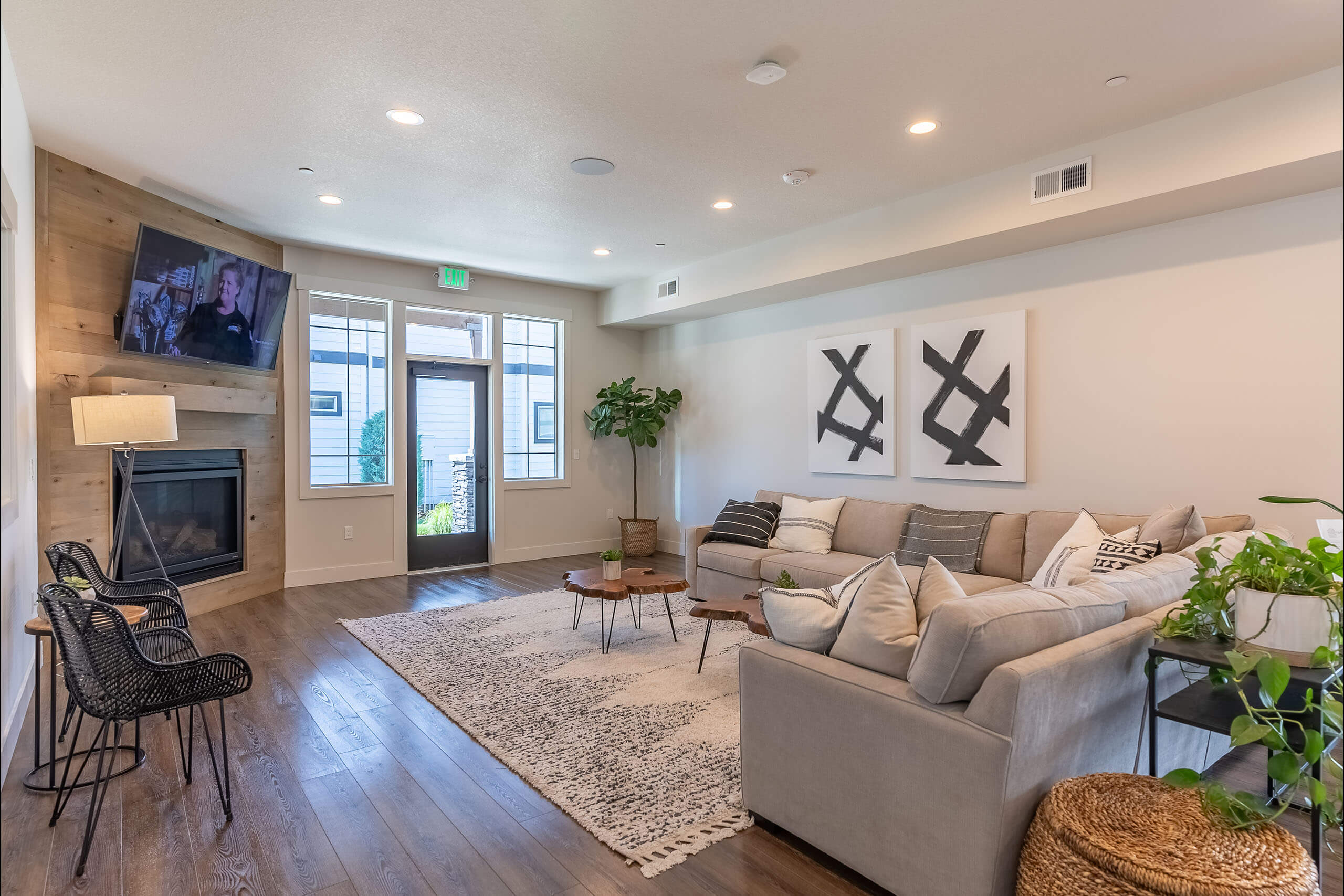 A living room with a grey couch, a television, and a rug.