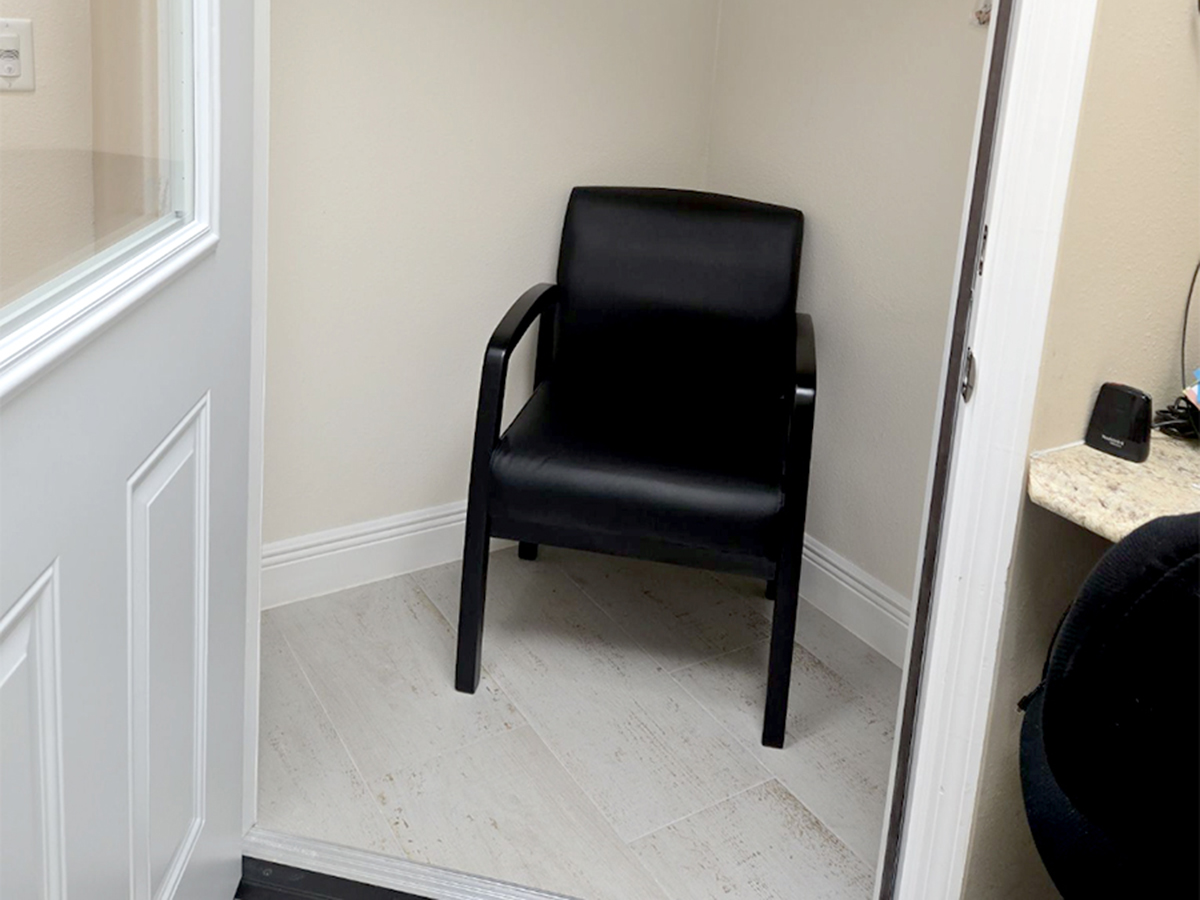 Interior photo of the inside of the hearing testing booth for AudioNova hearing clinic in Bushnell, FL
