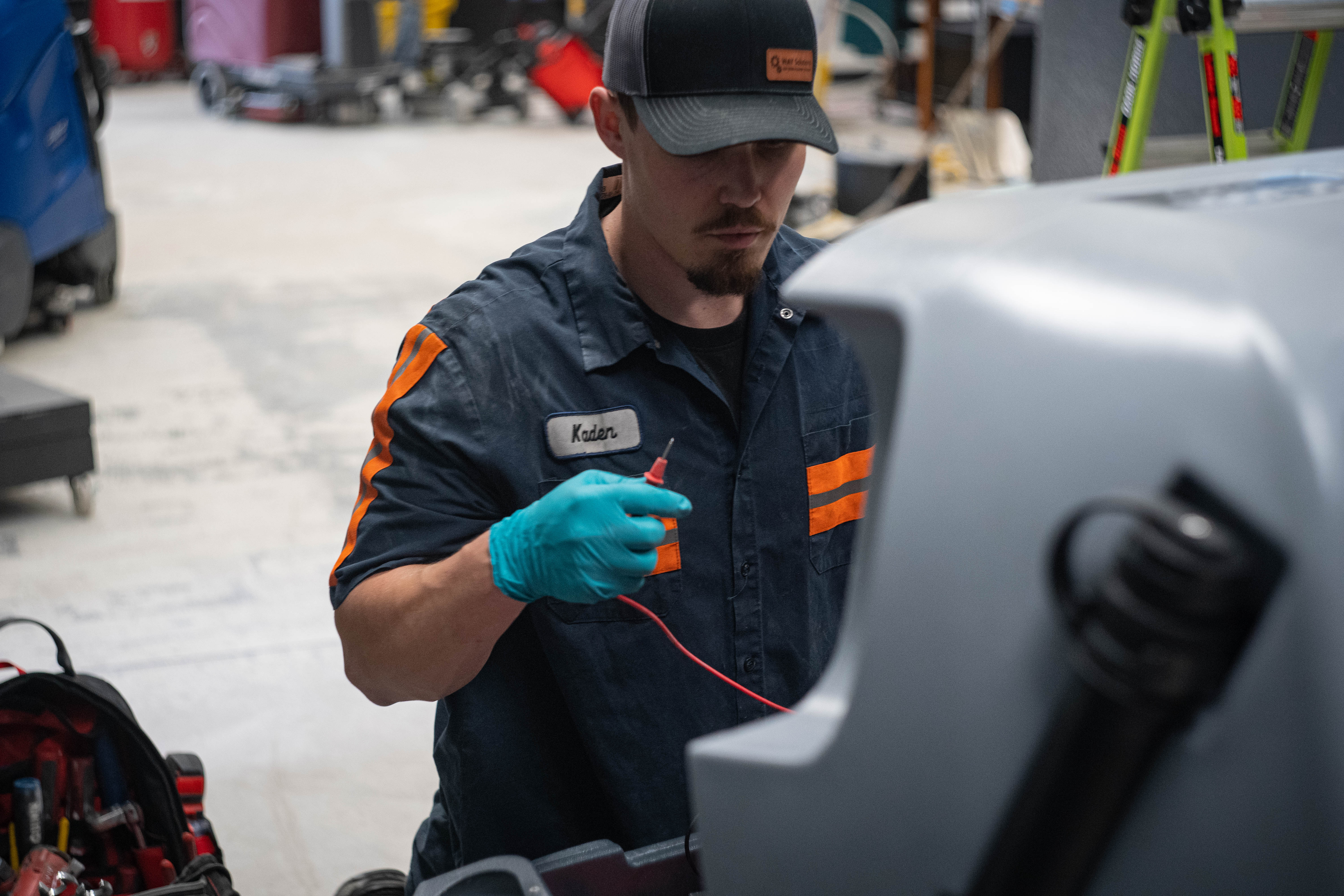 A WaySolutions technician performs a final quality control inspection on an i-mop XL floor scrubber. From compact, high-maneuverability scrubbers to large ride-on units, WaySolutions provides comprehensive maintenance and repair services for all major brands of supermarket cleaning equipment.