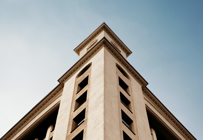 Bottom-up view of a classically designed building.