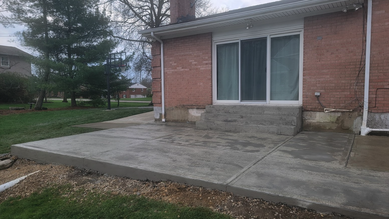 The owners of this home in Sycamore Twp wanted to move away from their decaying deck and a get a new concrete patio. They chose a clean look and needed the patio to tie into an existing sidewalk. We were able to help them out. Is you deck beginning to crumble? Call us to talk about getting a new, clean concrete patio.