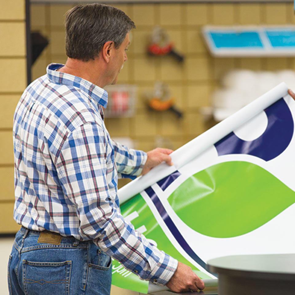 Customer looking at a large printed banner at The UPS Store