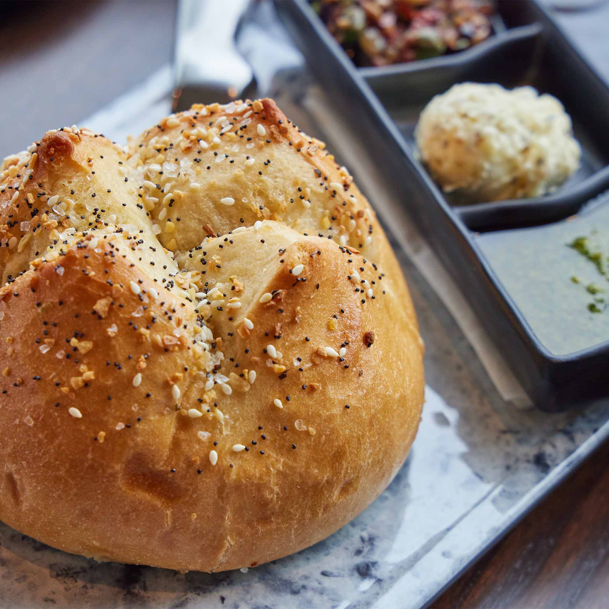 Shareable rustic roll served with pesto, herb & garlic butter, olive tapenade.