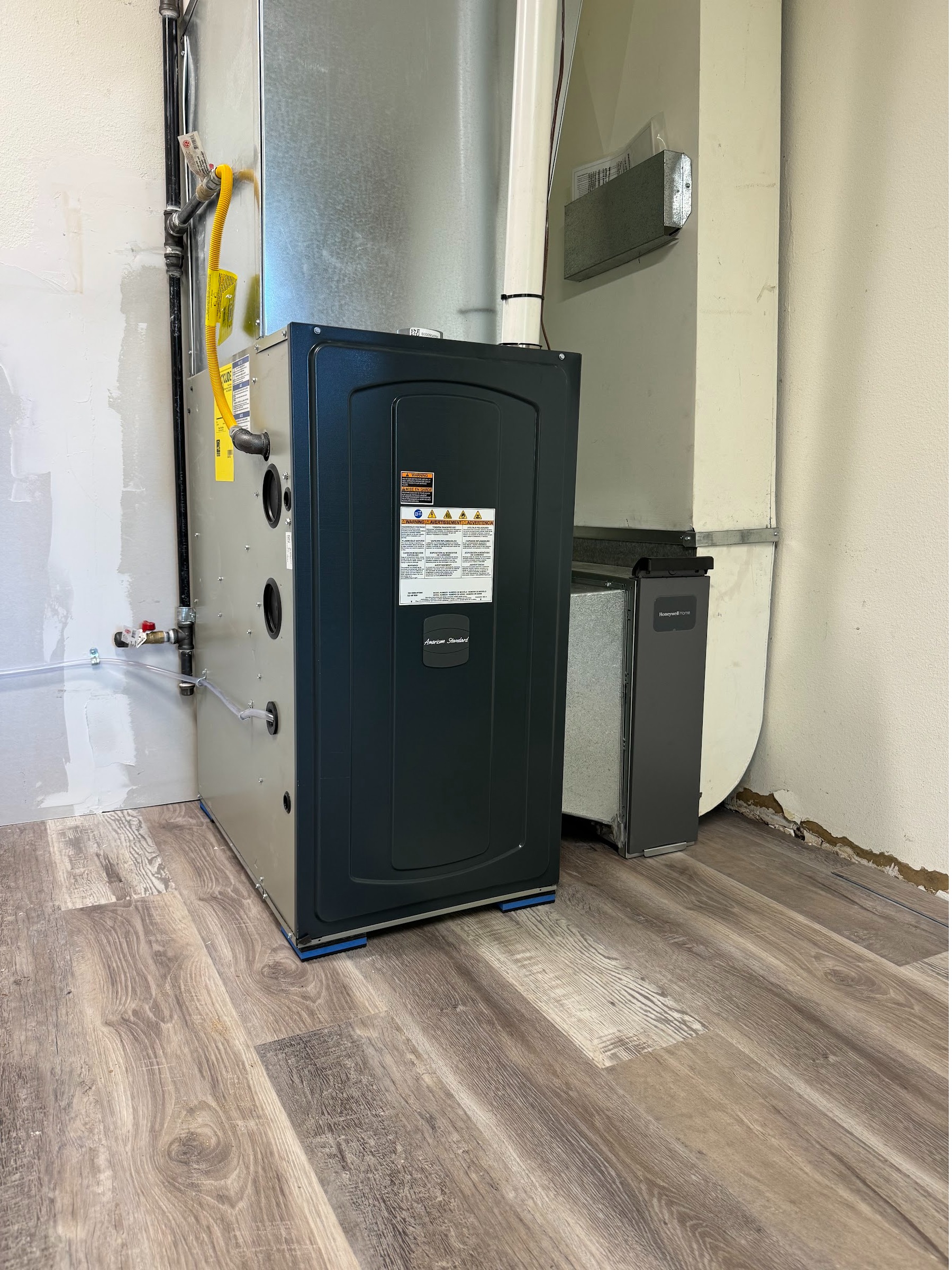 Heat pump water heater installed indoors on a finished floor. Heat pump water heater installation by Ready Energy Solutions.