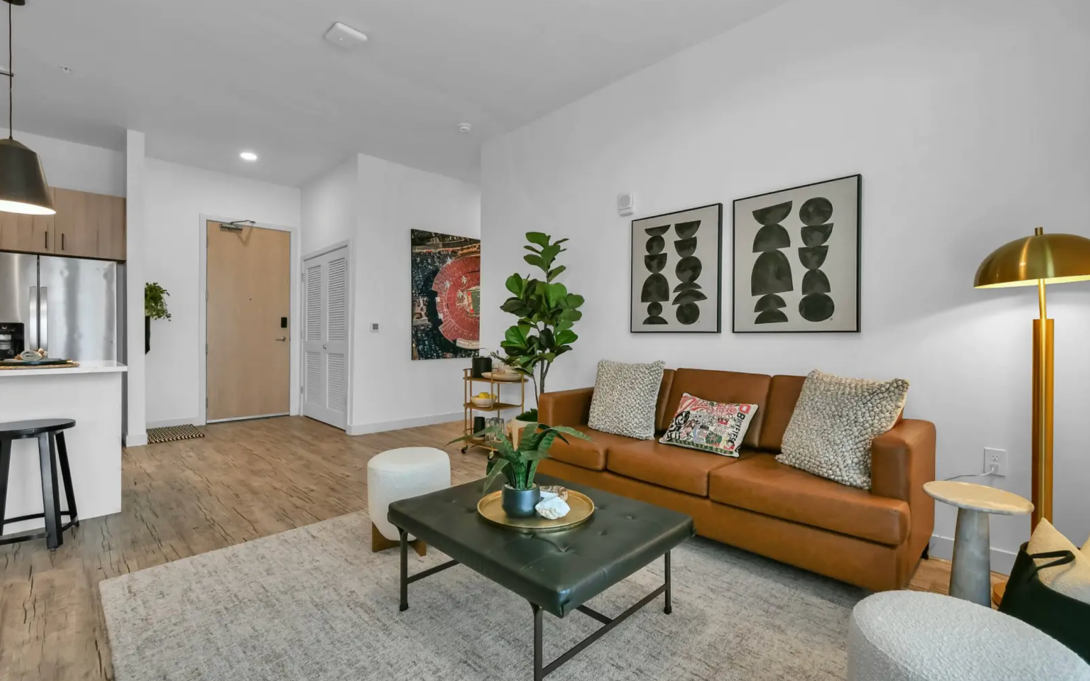 Fully furnished apartments with hardwood style flooring and mounted TVs. 
