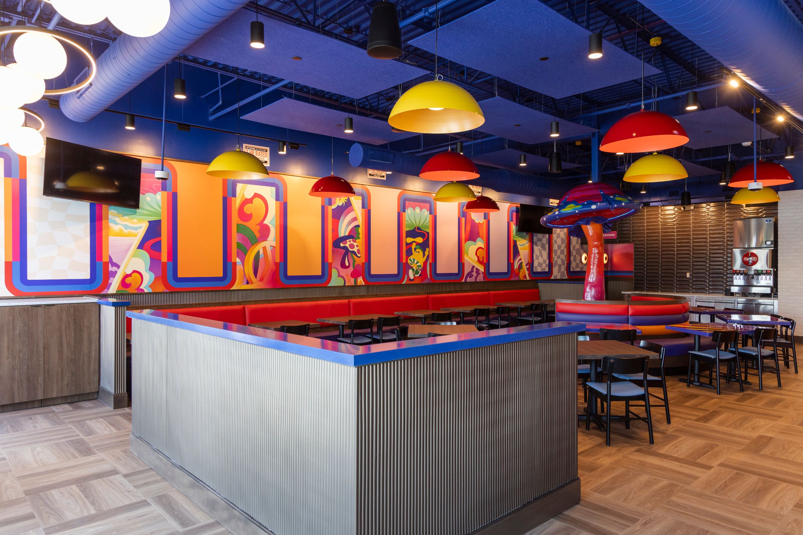 mellow mushroom newnan interior with colorful murals and mushroom sculpture