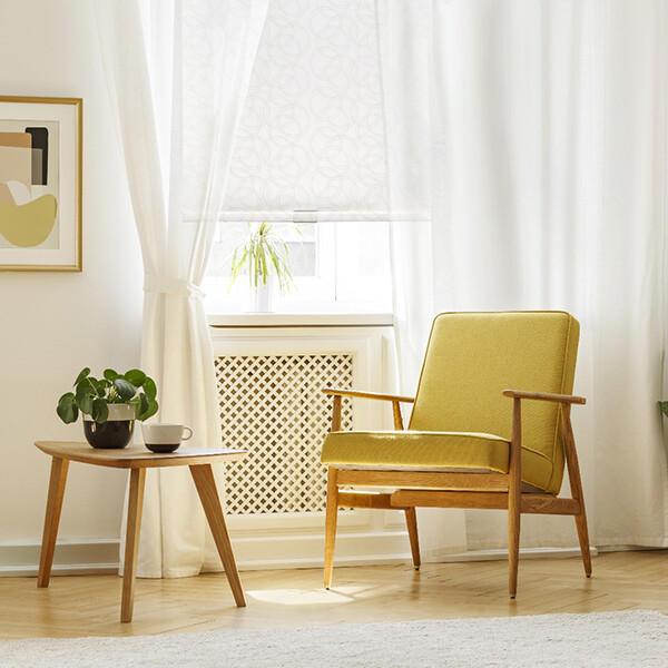 Brighten up your day in the most elegant way possible with layered window treatments. For this reading nook, the sheer drapery and cordless patterned roller shade allow warm light to pour in, providing plenty of illumination to relax with your favorite book!