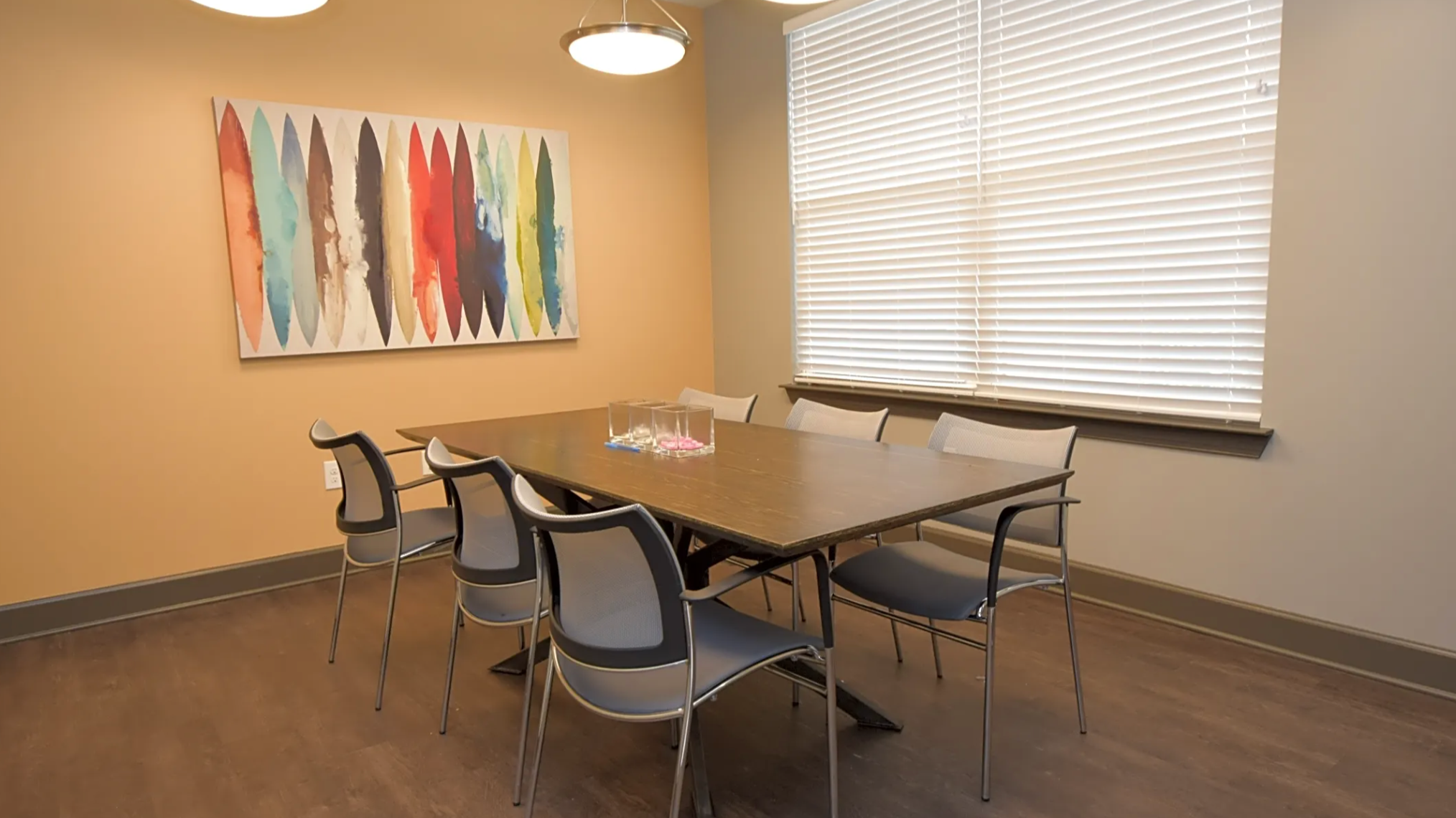 Private conference room with office table and plenty of seating.