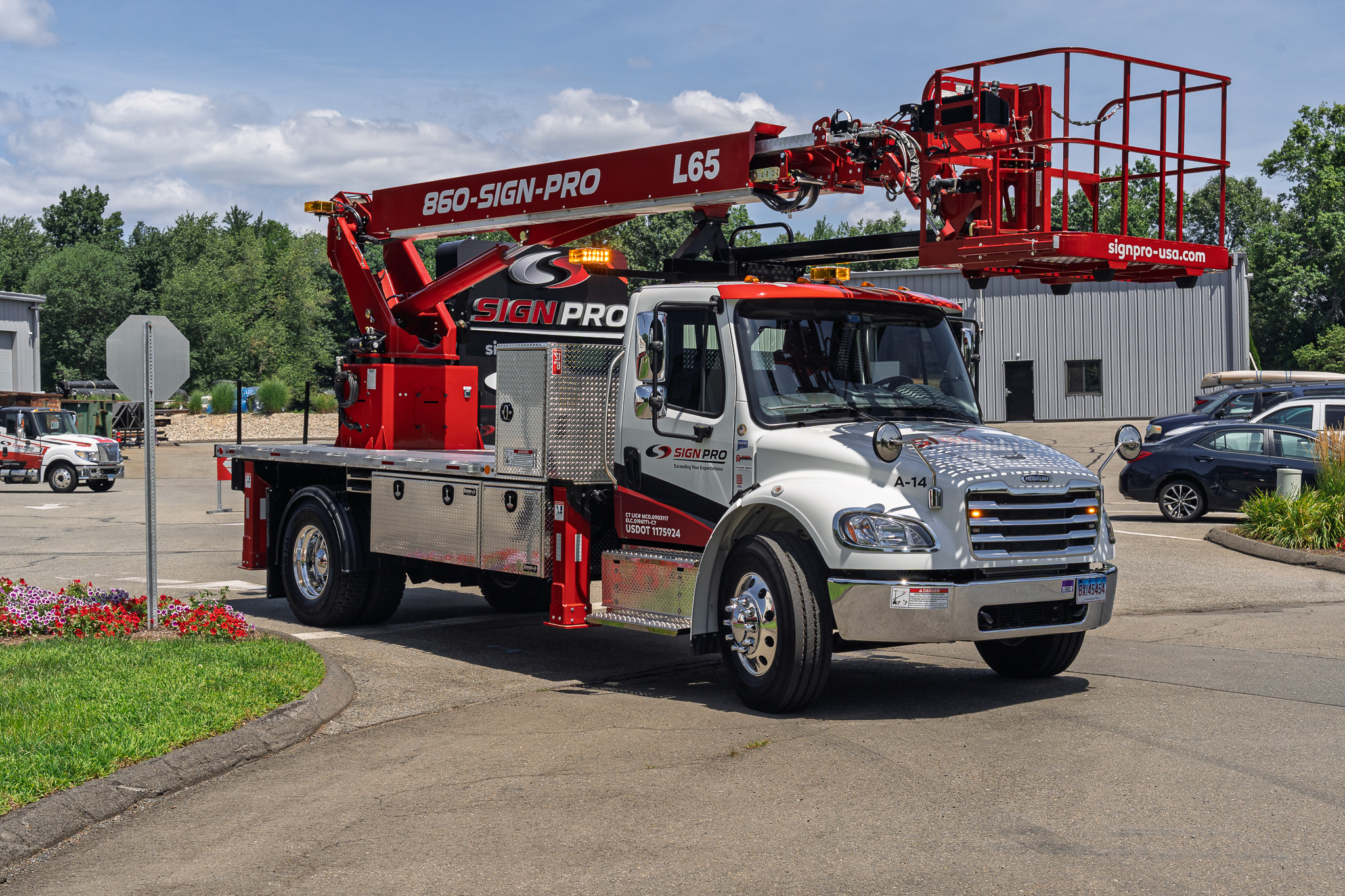Custom fleet graphics designed and applied by Sign Pro on a new Elliott L65 aerial lift truck built to support professional signage installation.