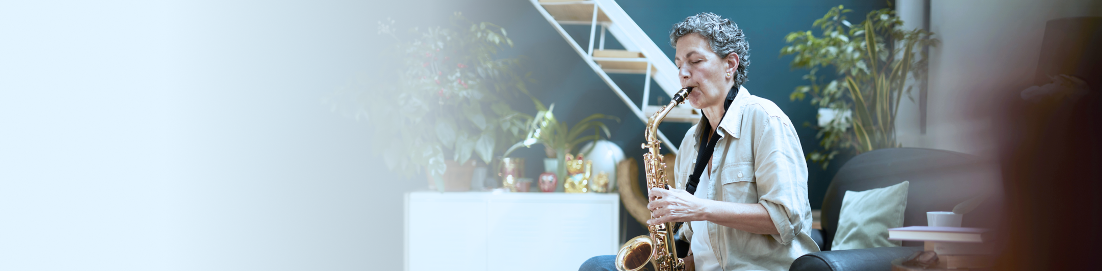 A woman practicing the saxophone in her nicely decorated living room.