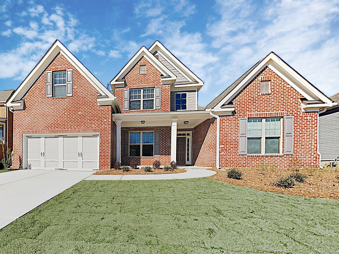 Gorgeous brick home with a two-car garage and covered porch at Invitation Homes Atlanta.