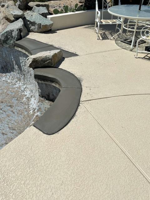 Pool deck and coping renovation featuring newly installed concrete coping along a curved pool edge.  
