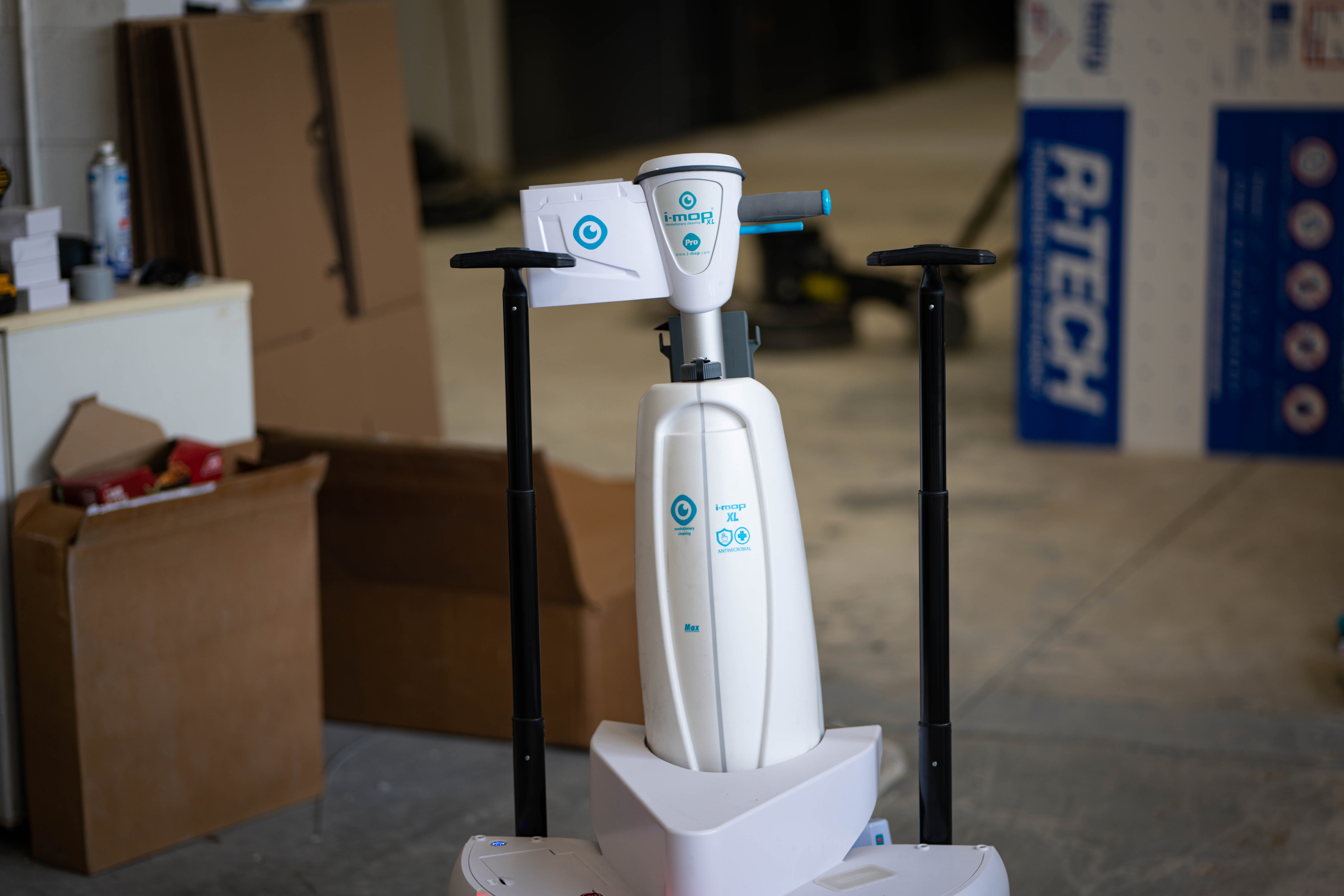 A sleek, high-tech i-mop XL commercial floor scrubber stands ready for servicing at the WaySolutions repair facility in Layton, Utah. Our cross-trained technicians specialize in the calibration and maintenance of next-generation, highly maneuverable cleaning equipment for modern commercial facilities.