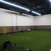 Dedicated functional training zone featuring artificial turf and specialized agility equipment. Our open, well-lit space is optimized for dynamic movement, mobility work, and sport-specific conditioning in a clean, professional environment.