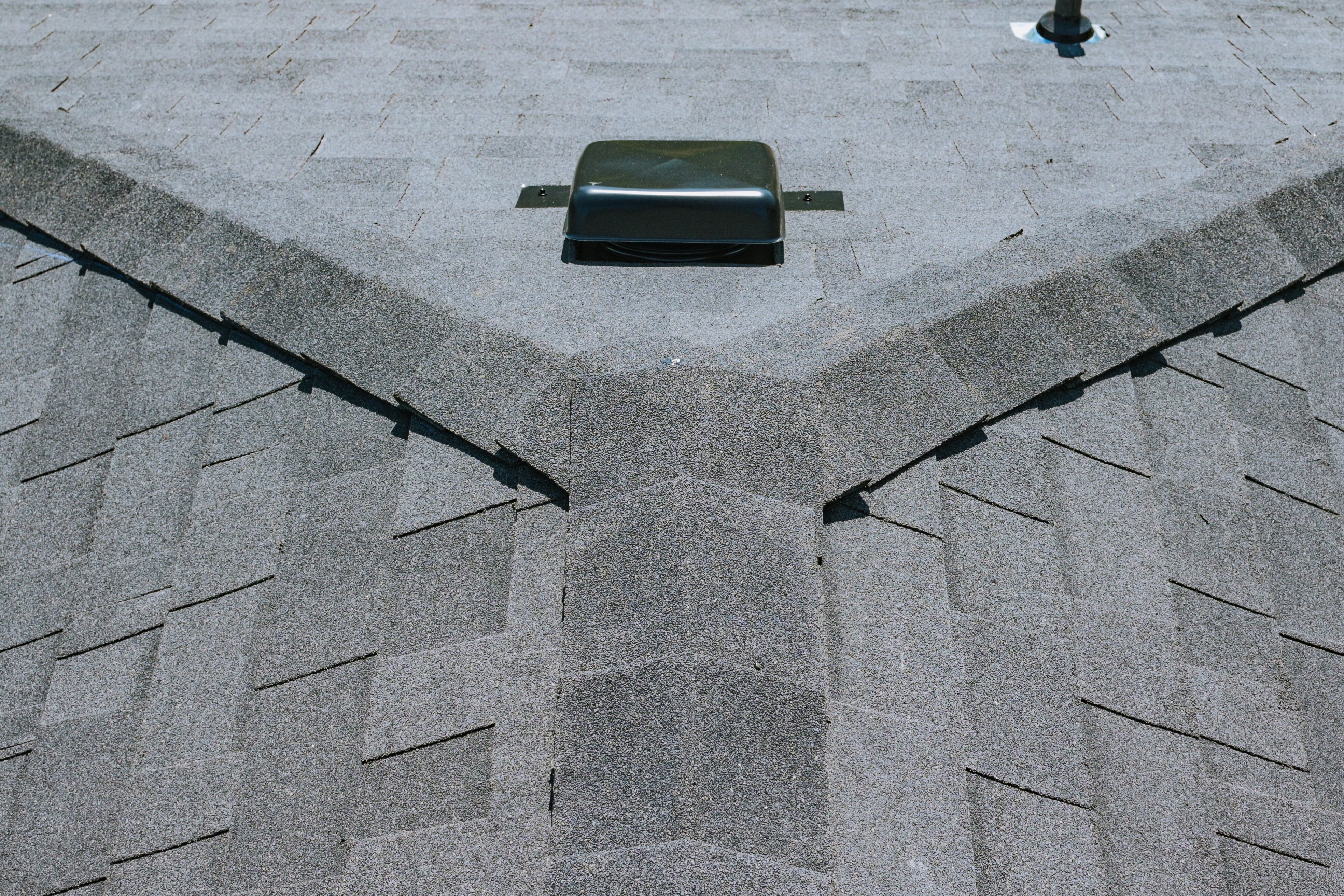 Residential roof ridge and hips finished with architectural asphalt shingles. 
