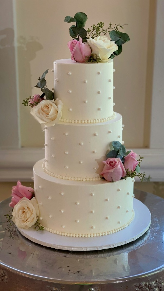 Elegant three-tier wedding cake from a top-rated in Deerfield Beach. 