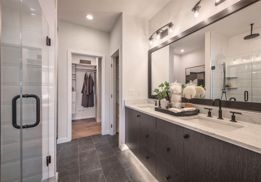 Spa-like primary bathrooms with dual sink vanities and luxe showers with seats