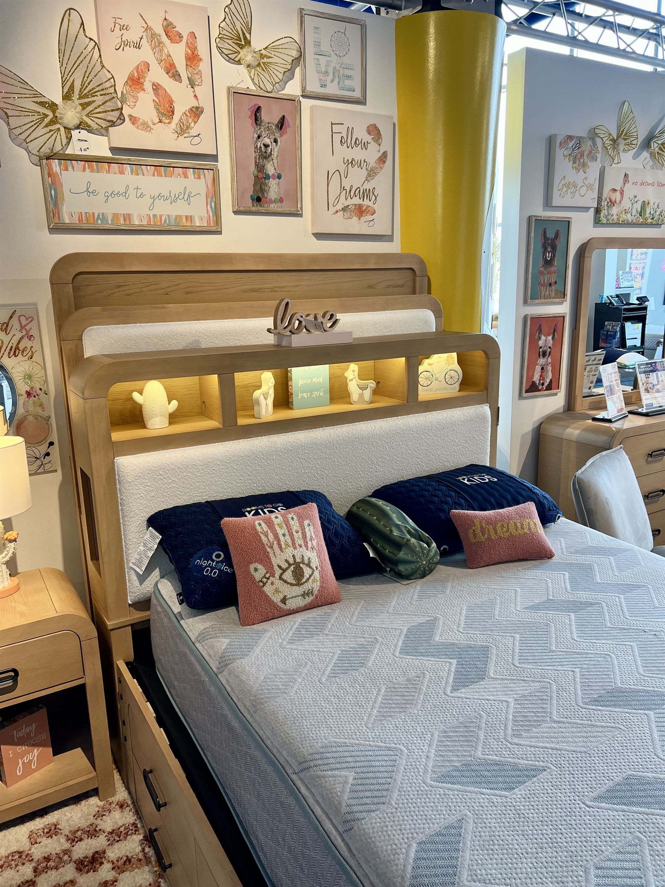 Shop this light wood bed with bookcase storage headboard at Rooms To Go Kids, styled with boho decor for 2026.