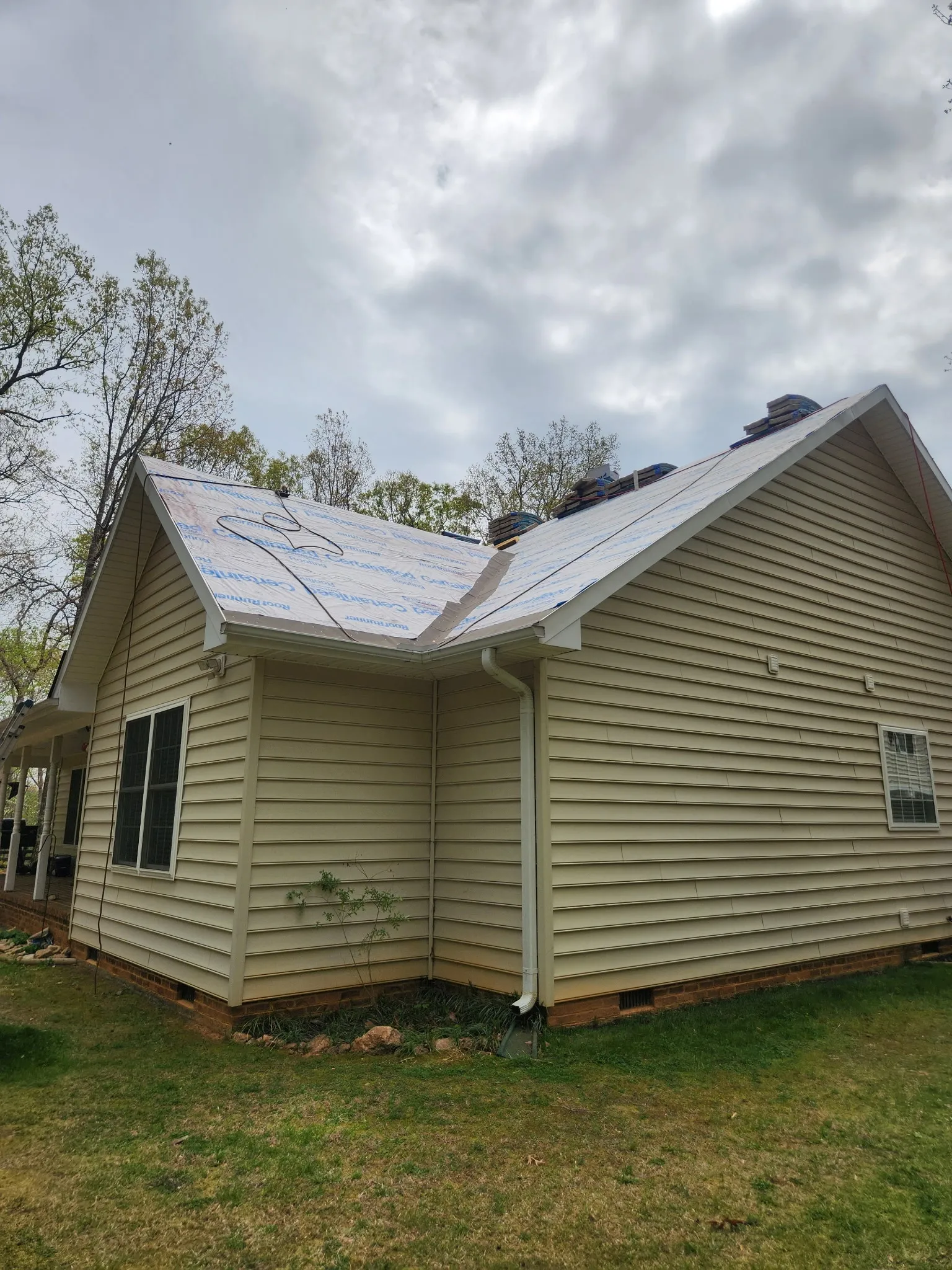 Home roof covered with protective underlayment during a residential replacement project. 