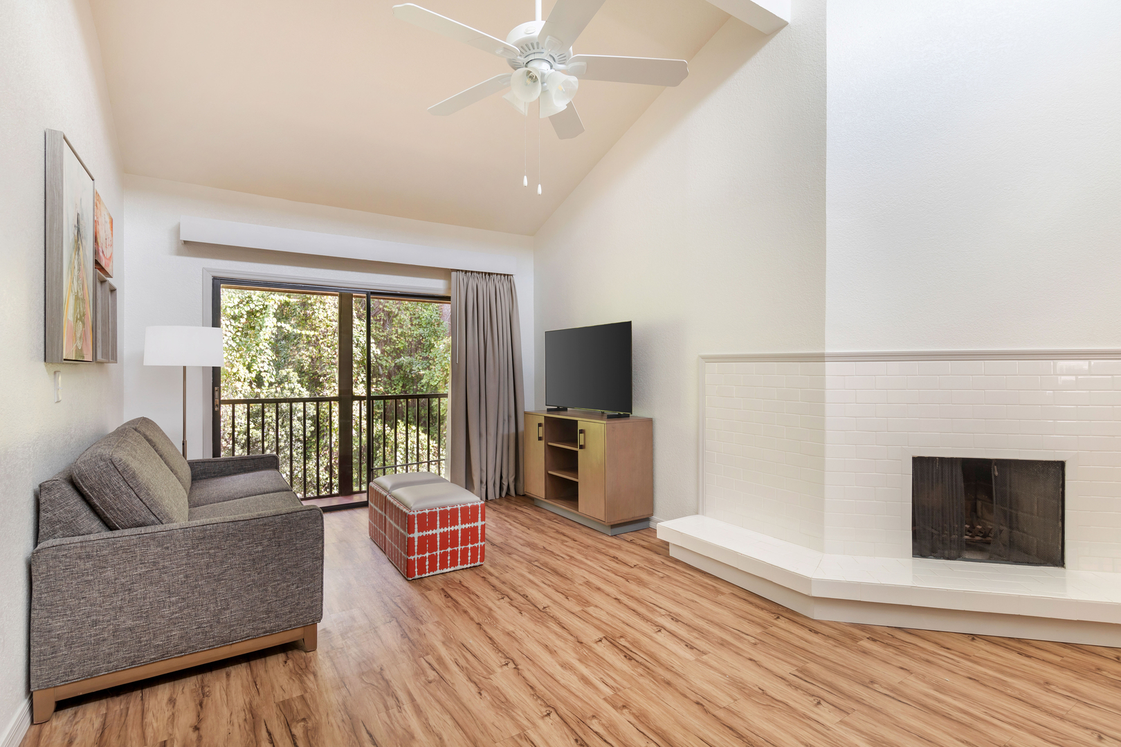 The living area in an accommodation at Bryan's Spanish Cove. It features a TV, seating, fireplace, a balcony.