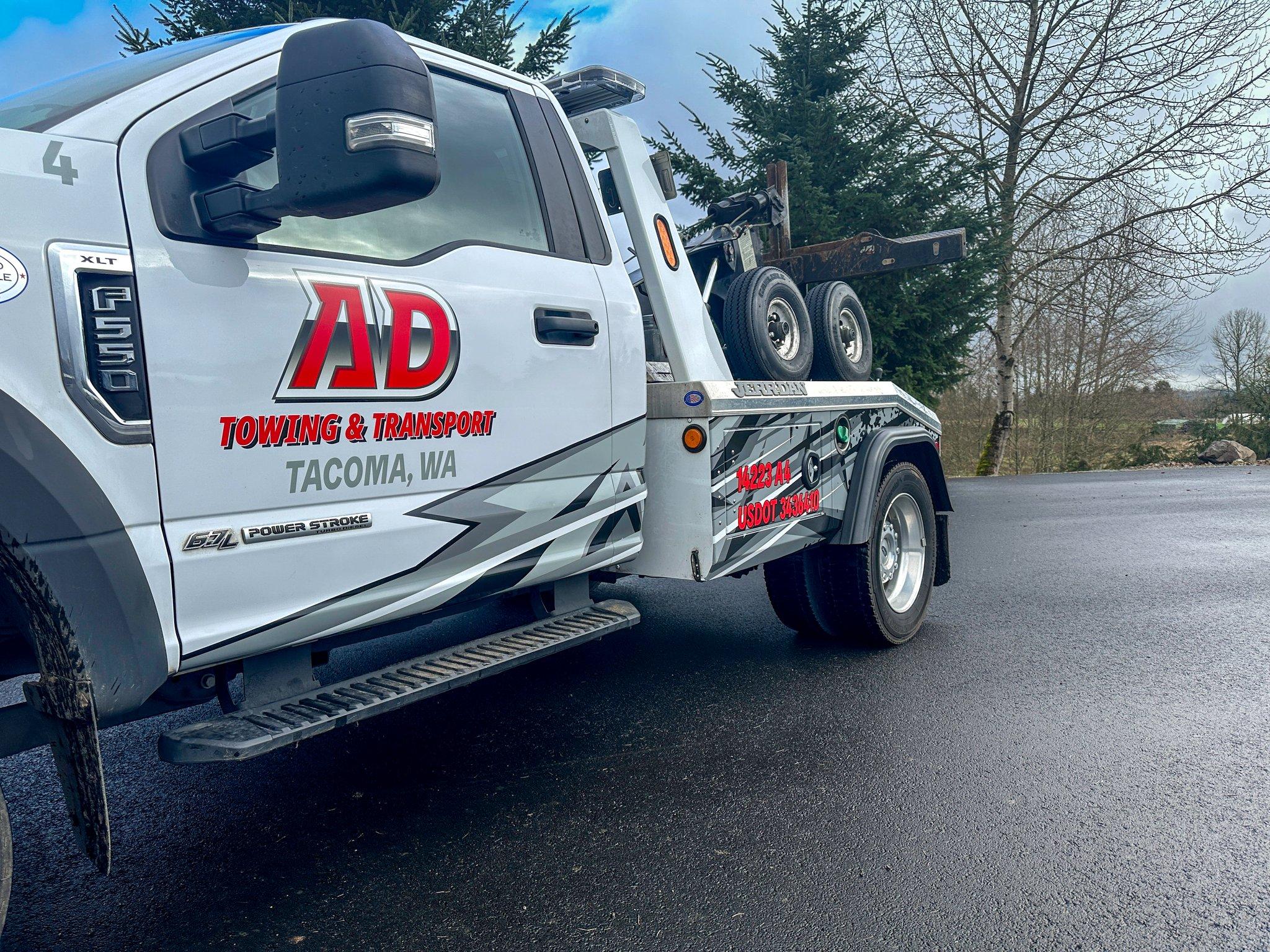 Door lettering and partial graphics on a Ford F-550 tow truck for AD Towing & Transport, produced by Ardor Printing.