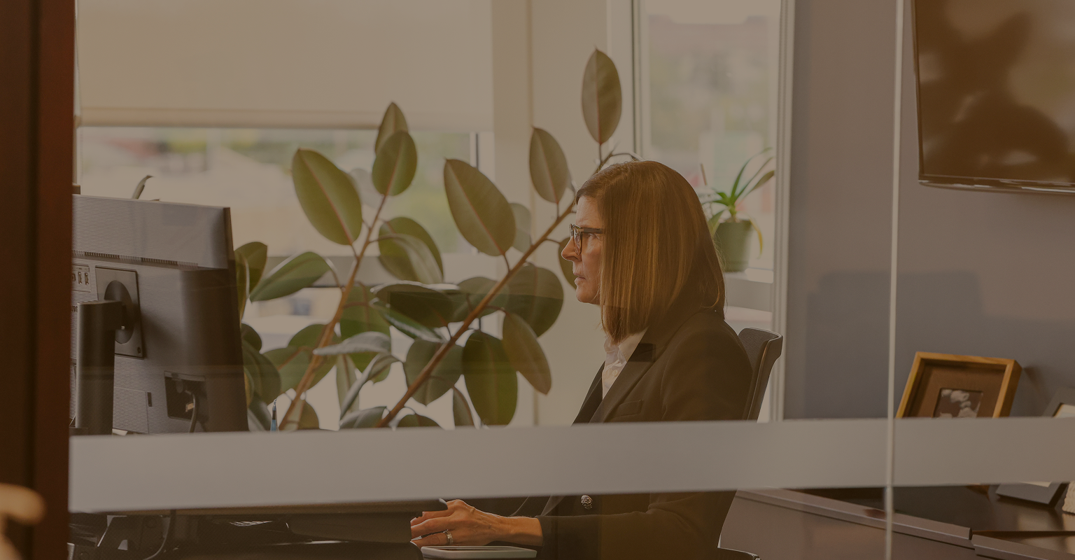 Kathy Dion engaged in focused work in her office.