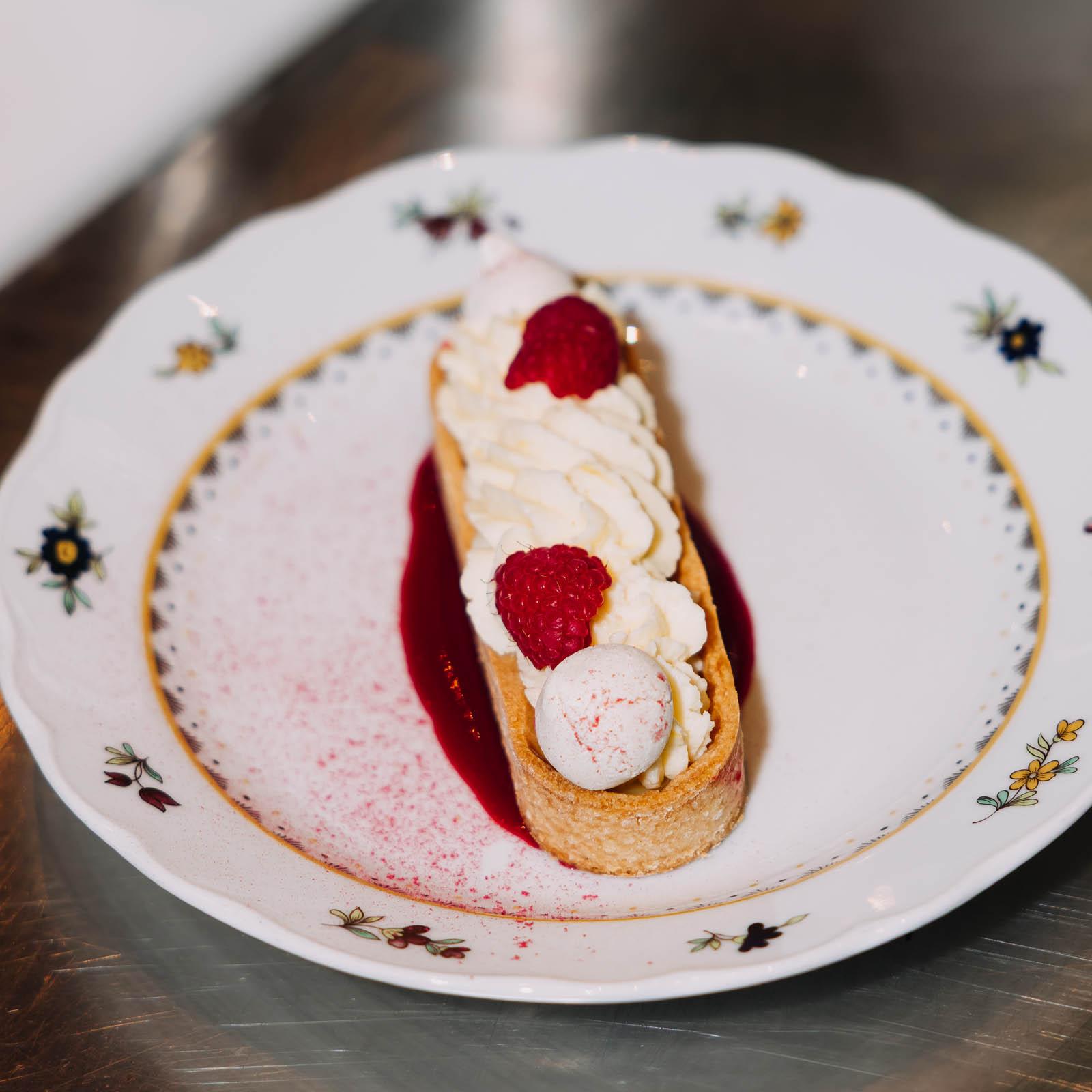 Lemon Tart with whipped cream and raspberries