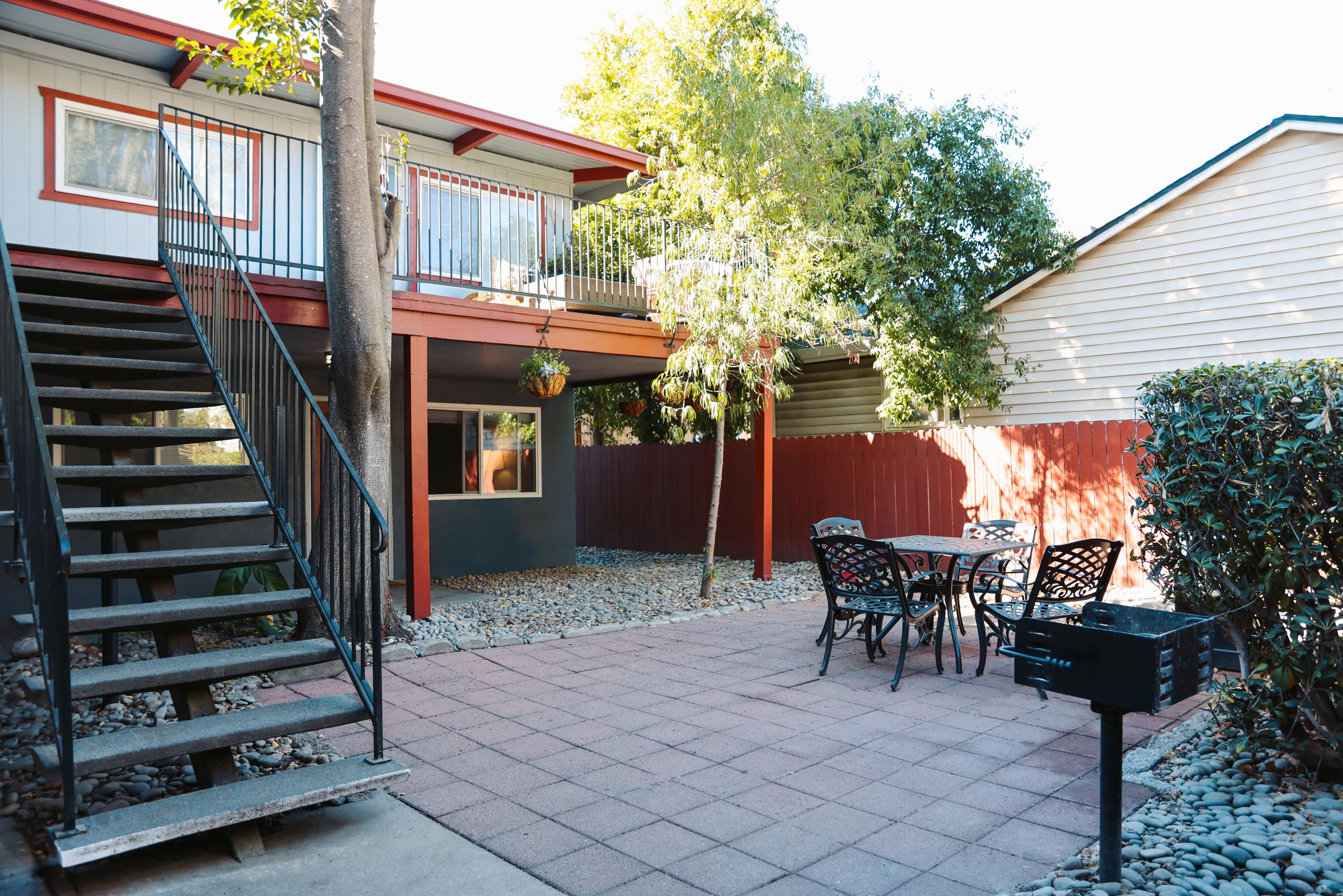 A patio with a table and chairs and a mailbox at I Street Apartments, Davis, CA 95616