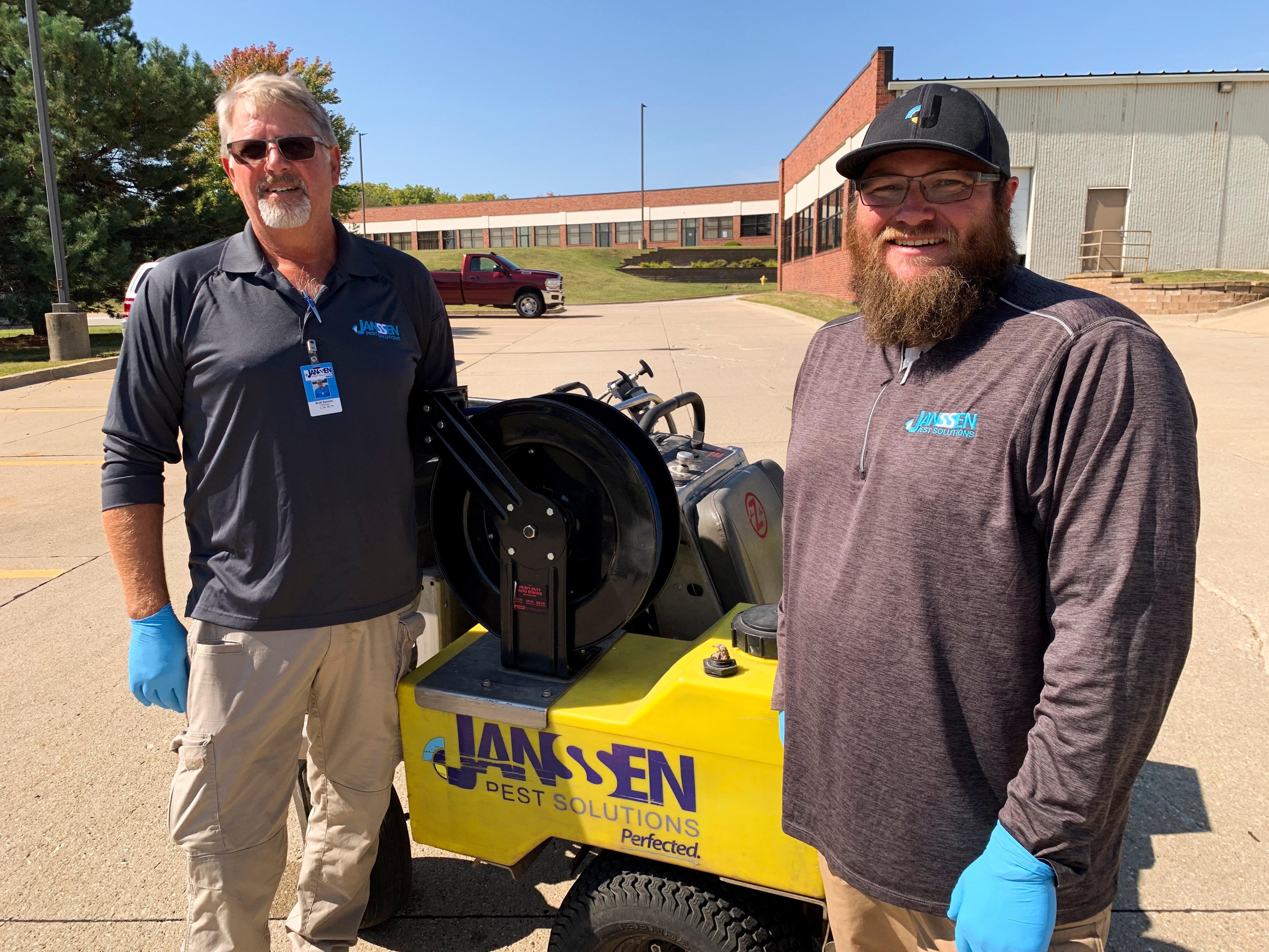 Janssen Pest Solutions technicians outside commercial property in Des Moines, Iowa.