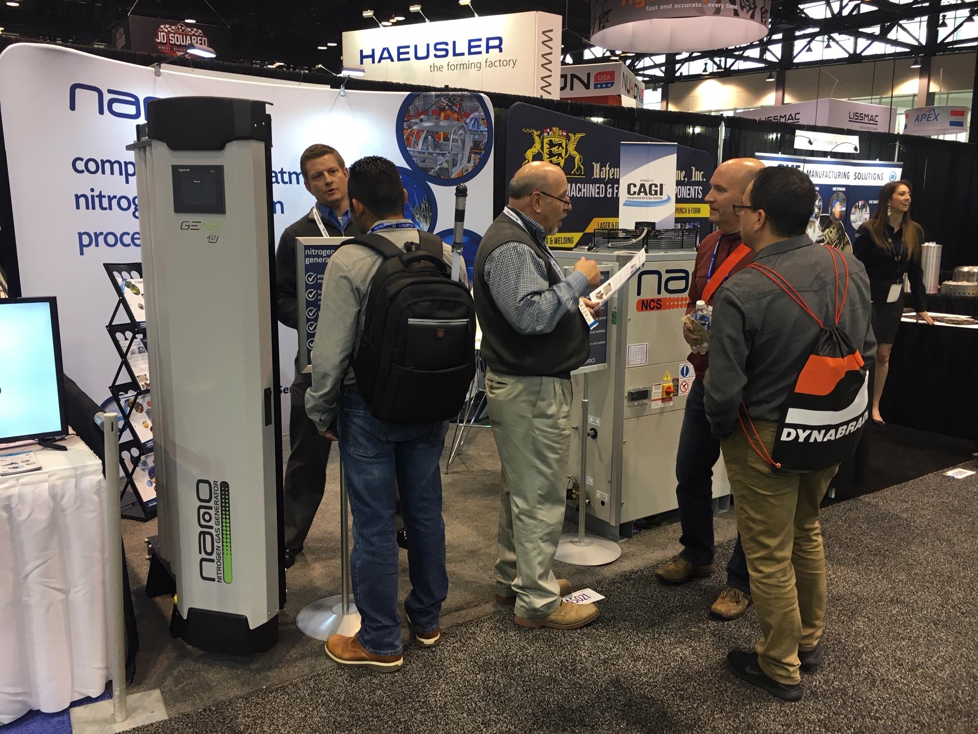 nano employees discussing nano nitrogen generators and process chillers at a metal fabrication industry tradeshow
