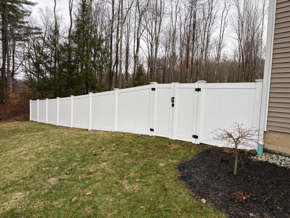 This project features 6-foot white vinyl privacy panels designed for durability and low maintenance