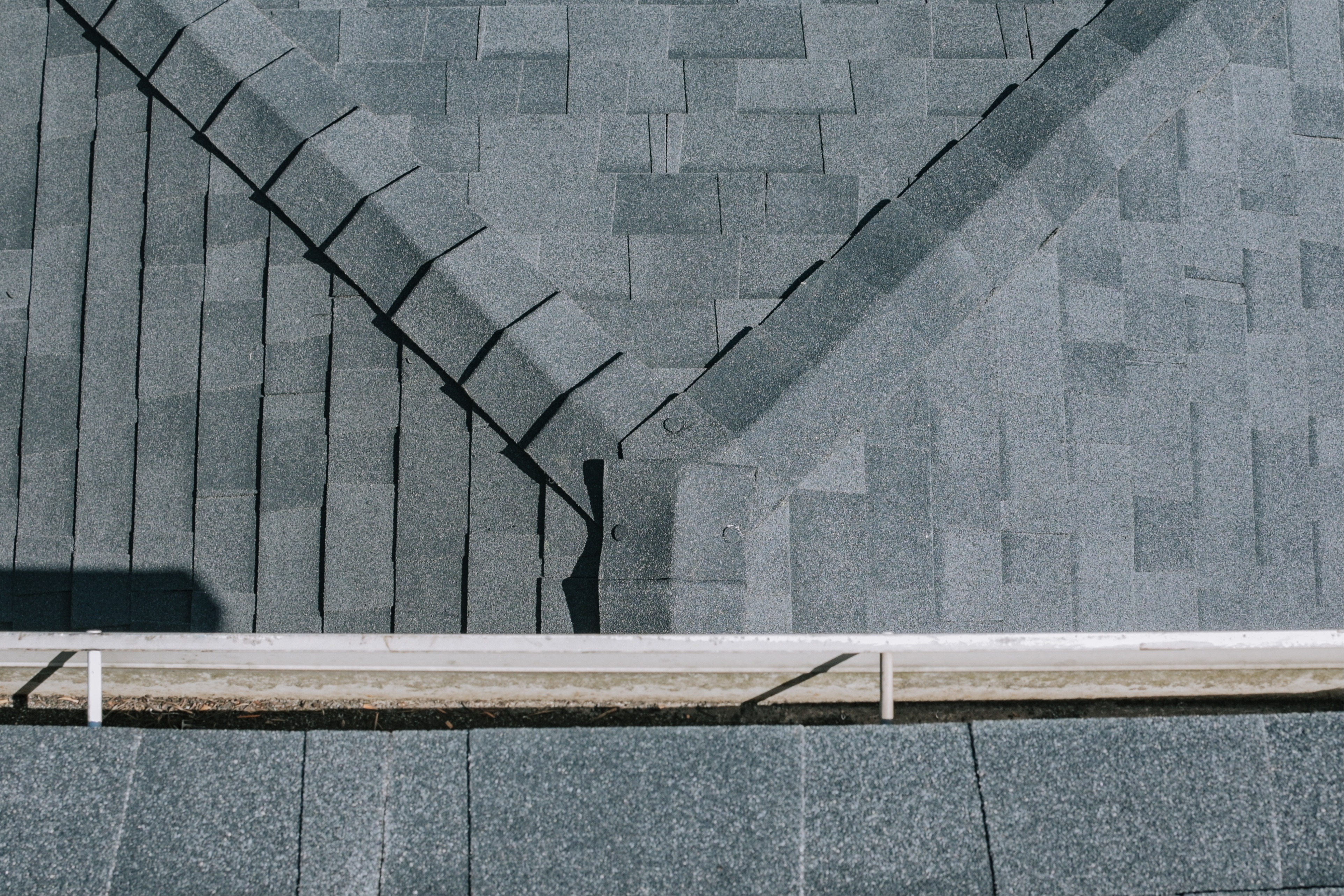 Finished roof ridge detail showing clean shingle alignment and water-shedding layout. 