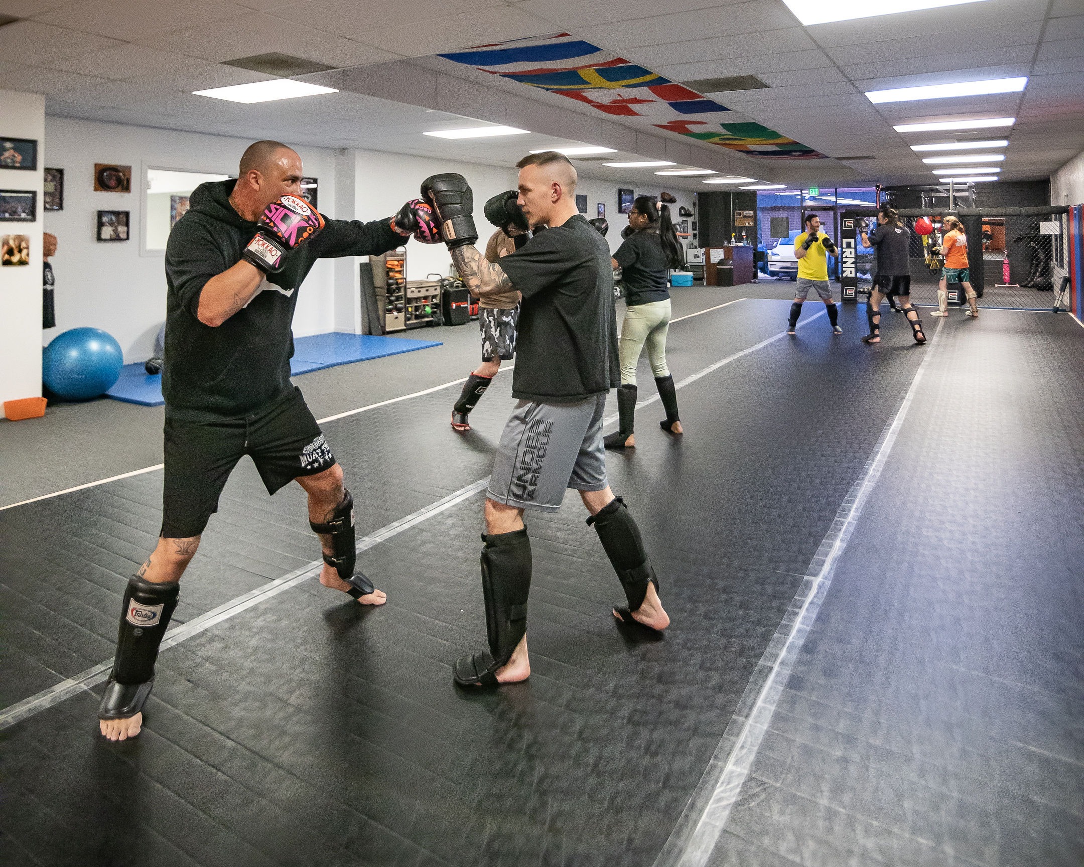 Spacious open-floor training area equipped for both strength and functional training, creating a versatile environment for private coaching, kickboxing drills, and dynamic fitness routines.