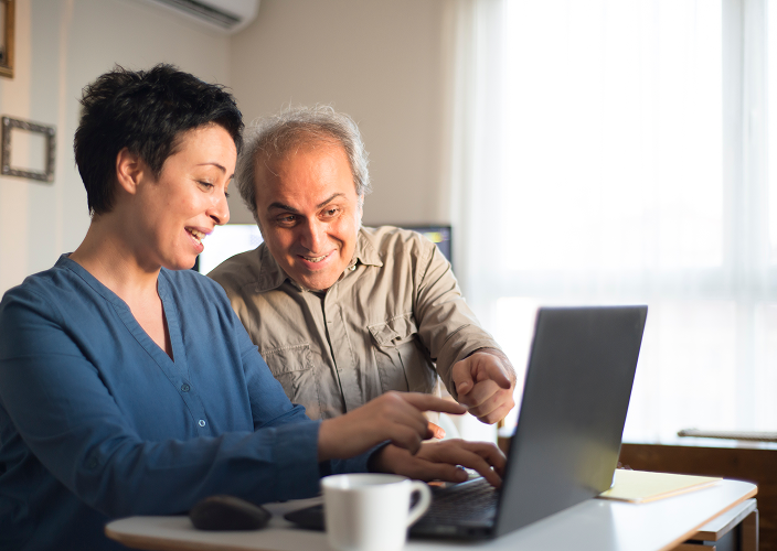 A couple looking at a computer.