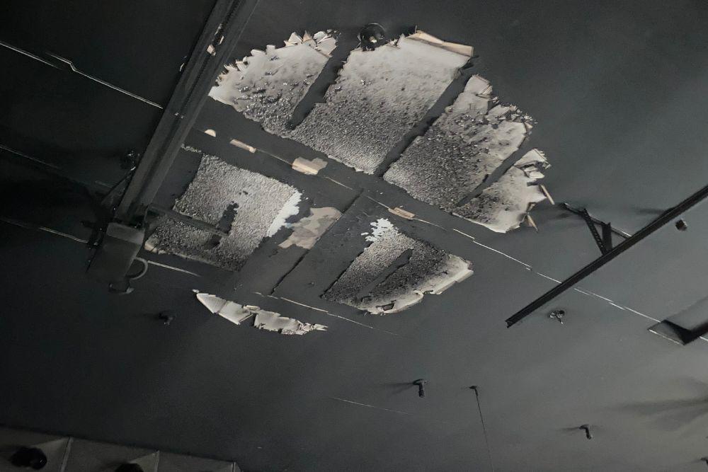 Fire damage restoration.  Pictured here is a ceiling damaged by a shop fire.