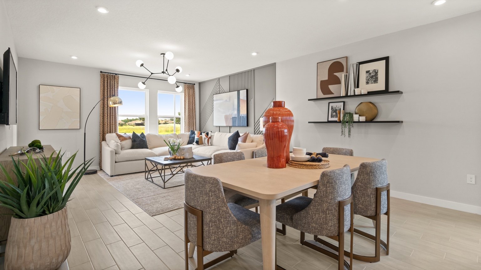 The Jupiter Model Home Open Concept Living and Dining Area at Grasslands West by DRB Homes