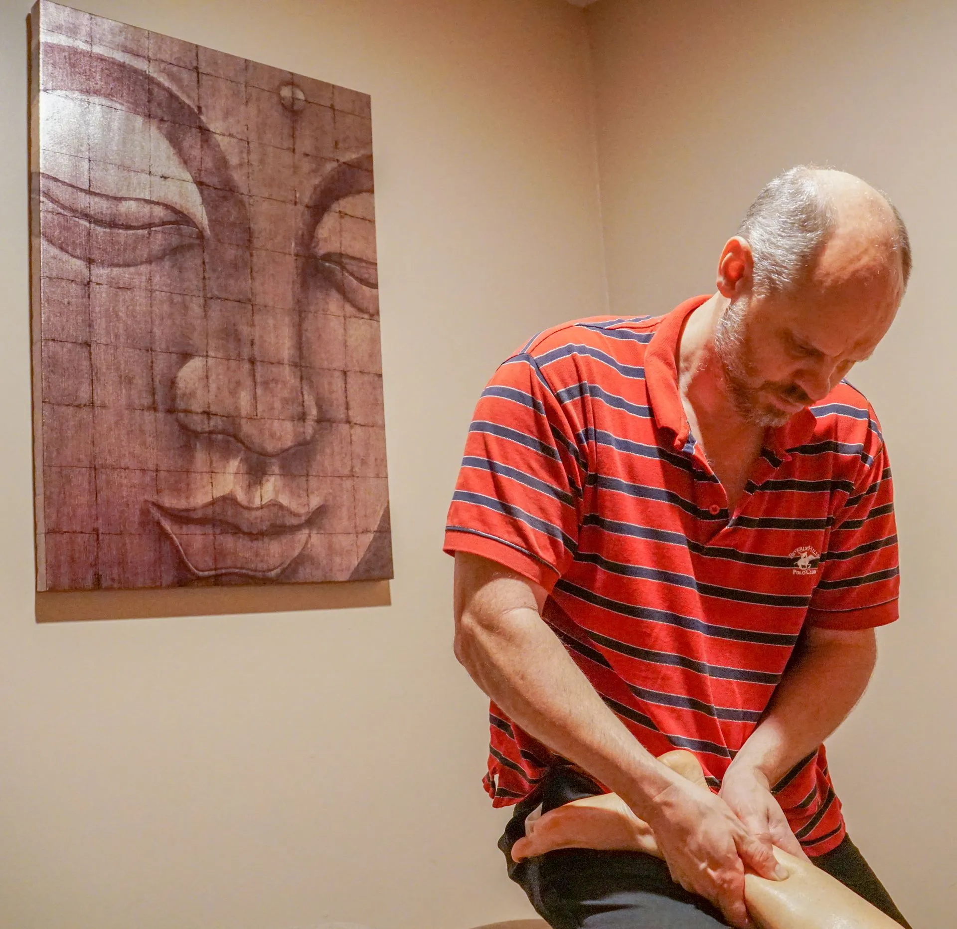 Professional massage therapist delivering customized bodywork treatment focused on muscle recovery,  